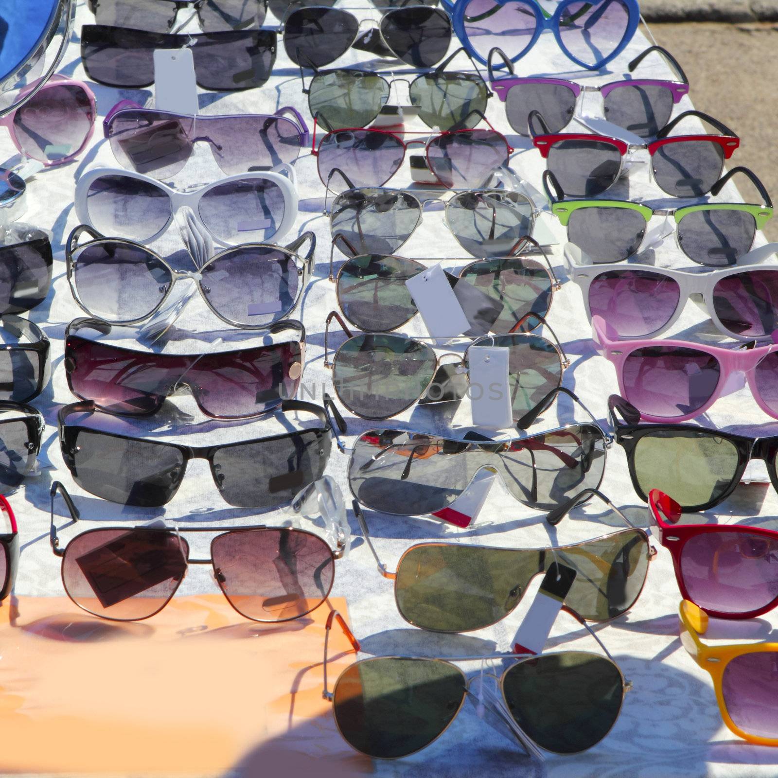 many sunglasses outdoor market shop colorful display
