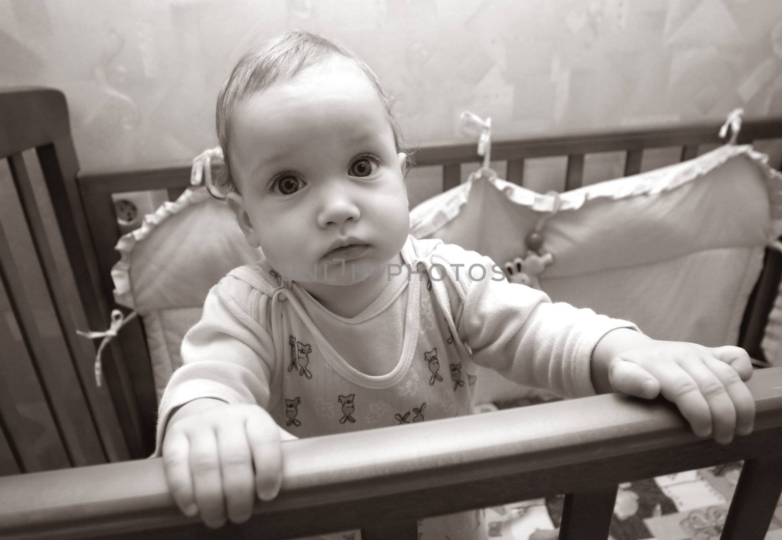 The small child 4 months in a bed. b/w+sepia