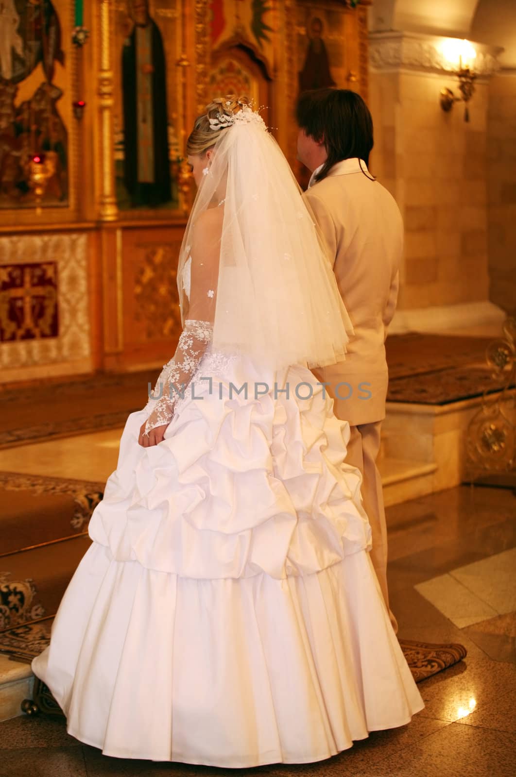 The groom and the bride on wedding ceremony in church