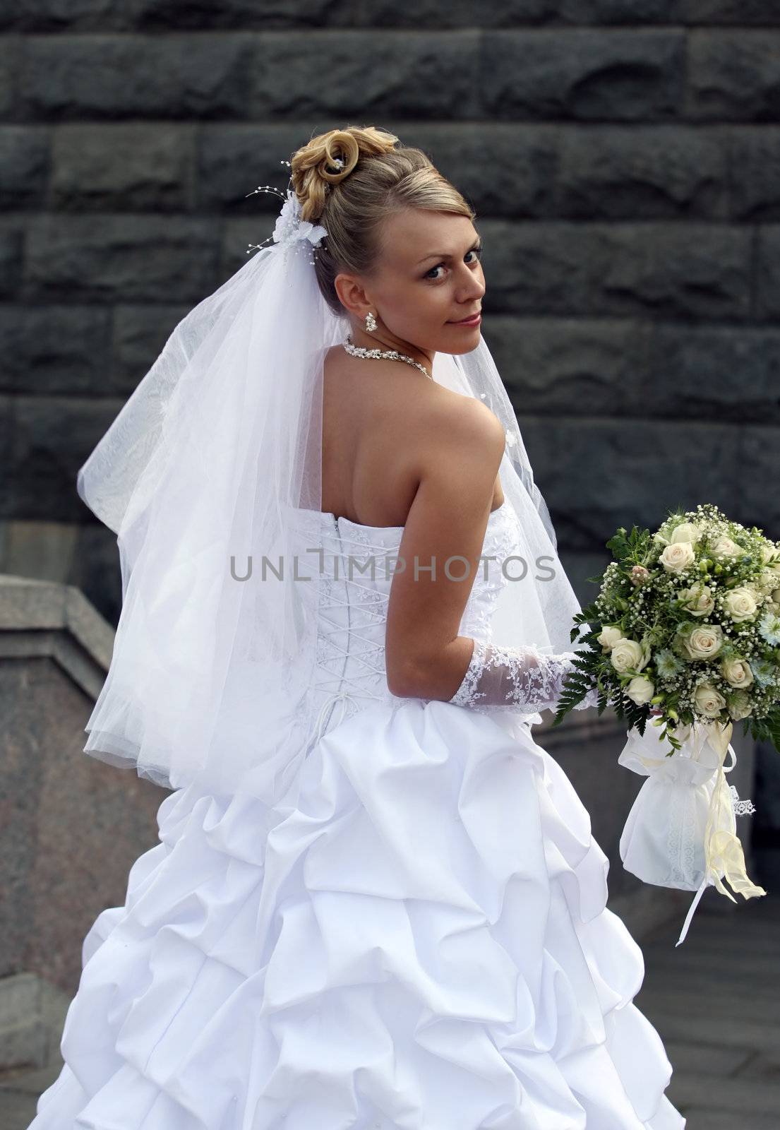 Portrait of the beautiful bride with a bouquet