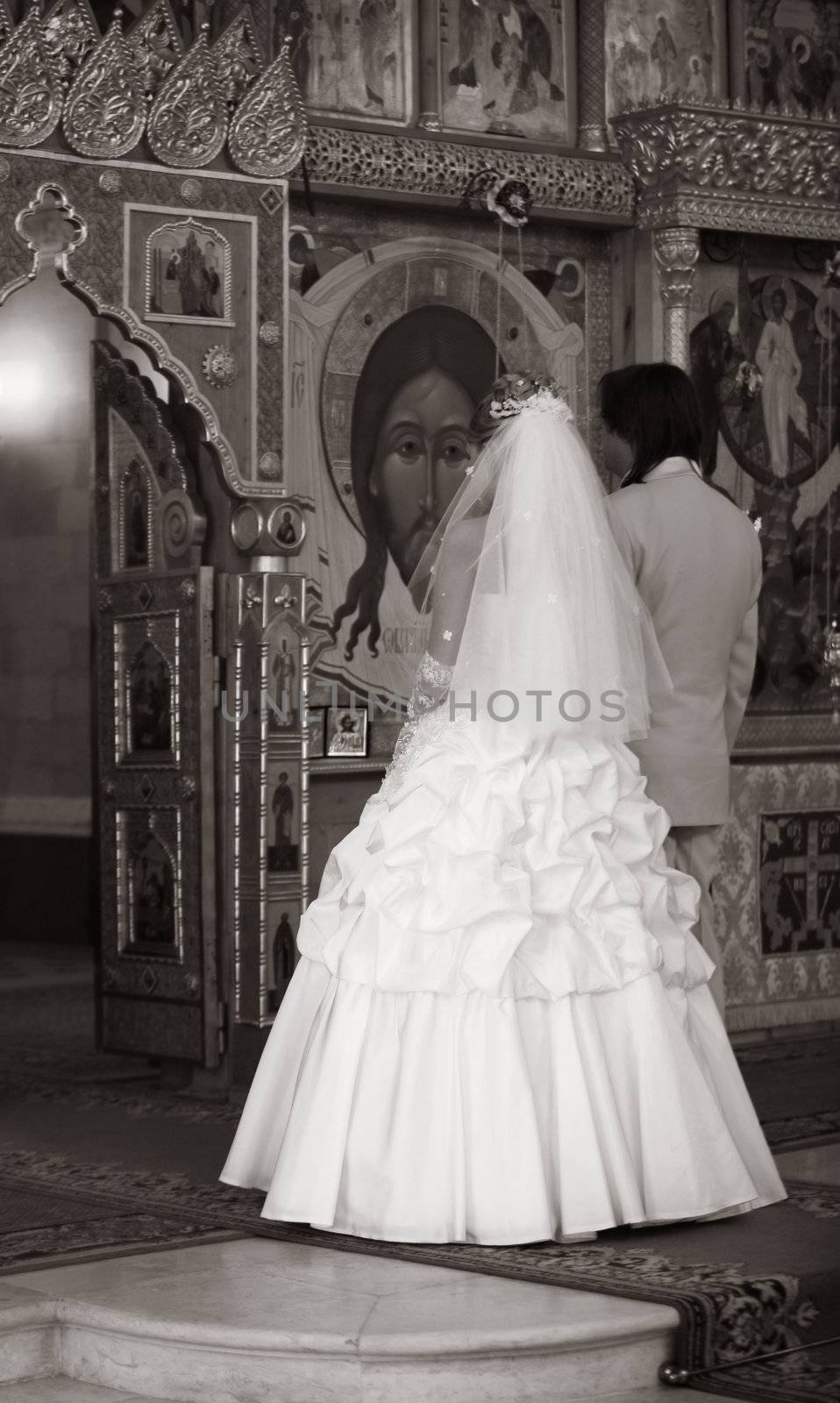 The groom and the bride on wedding ceremony in church