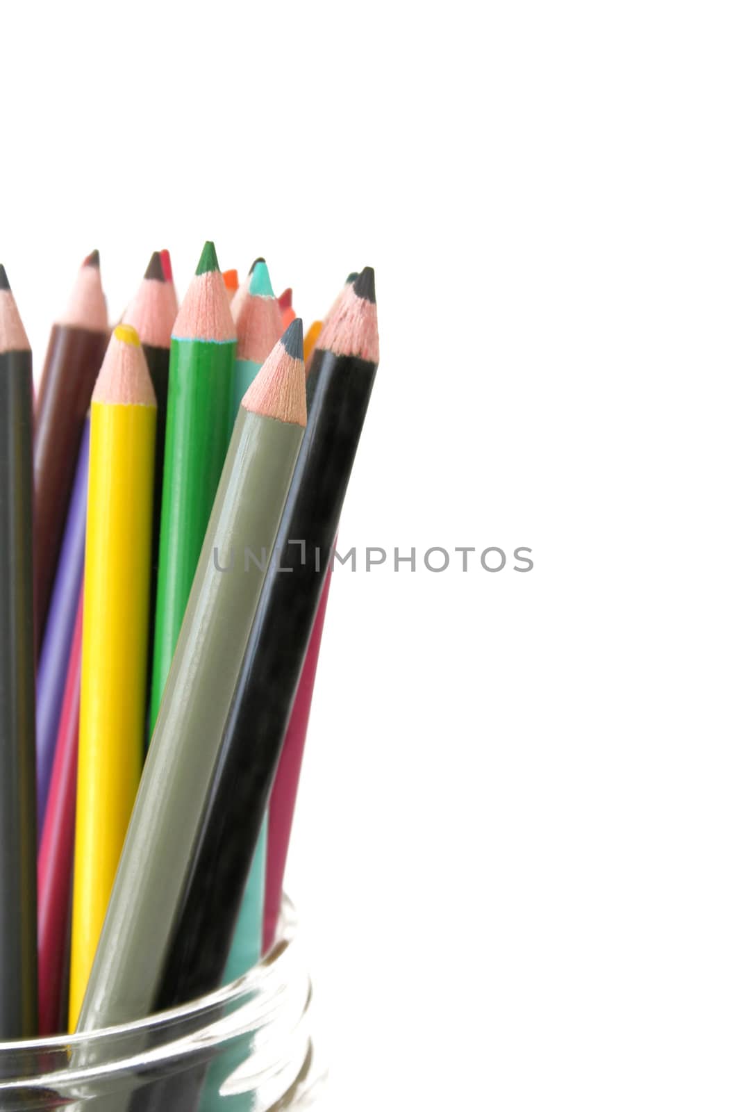 Colorful pencils in a jar against a white background.  Copy space available. Used a shallow depth of field with selective focus.