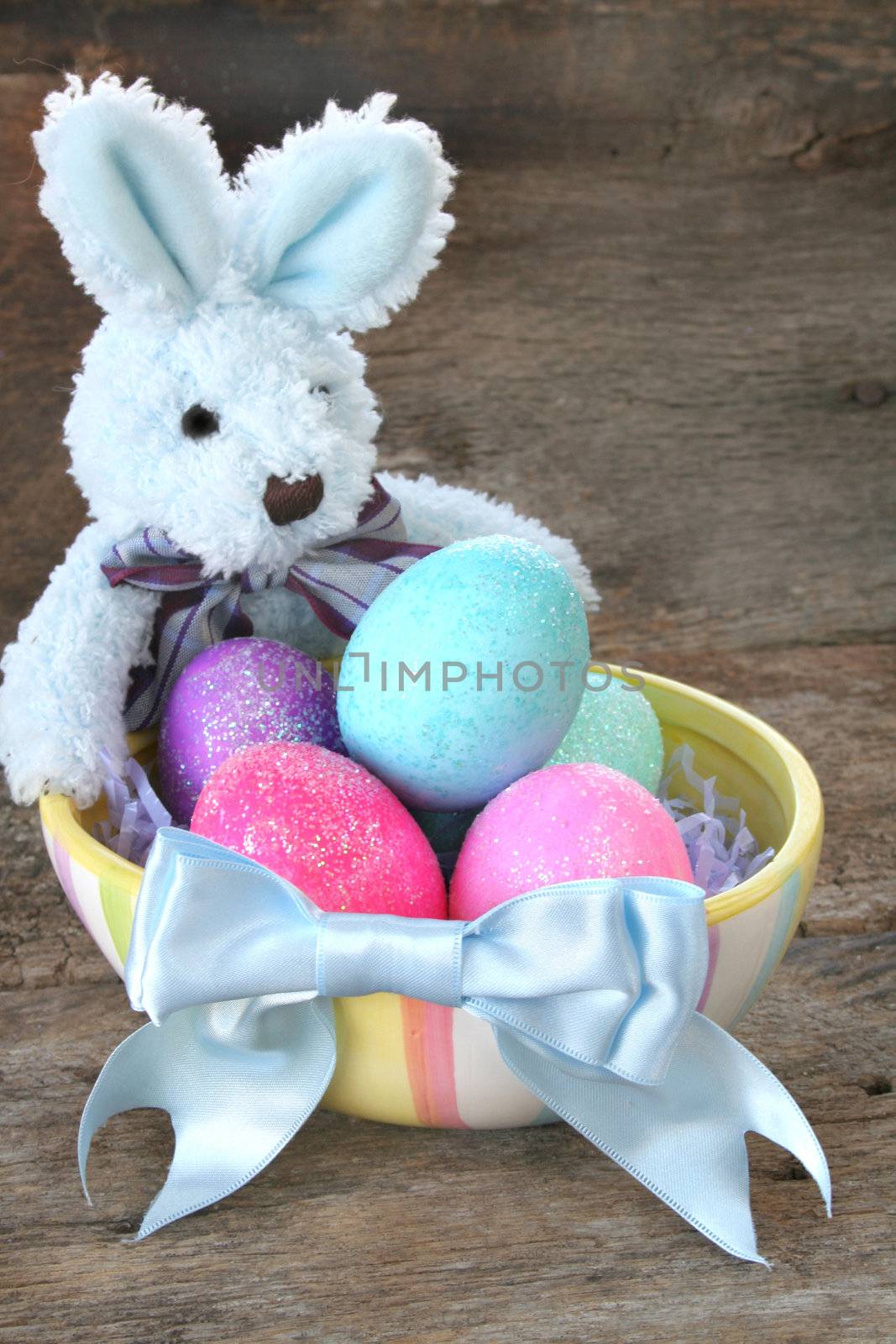 Stuffed Easter bunny with Easter eggs and a pretty blue bow.