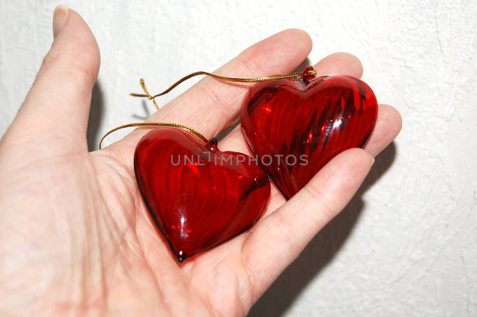 the two red hearts in the hand 