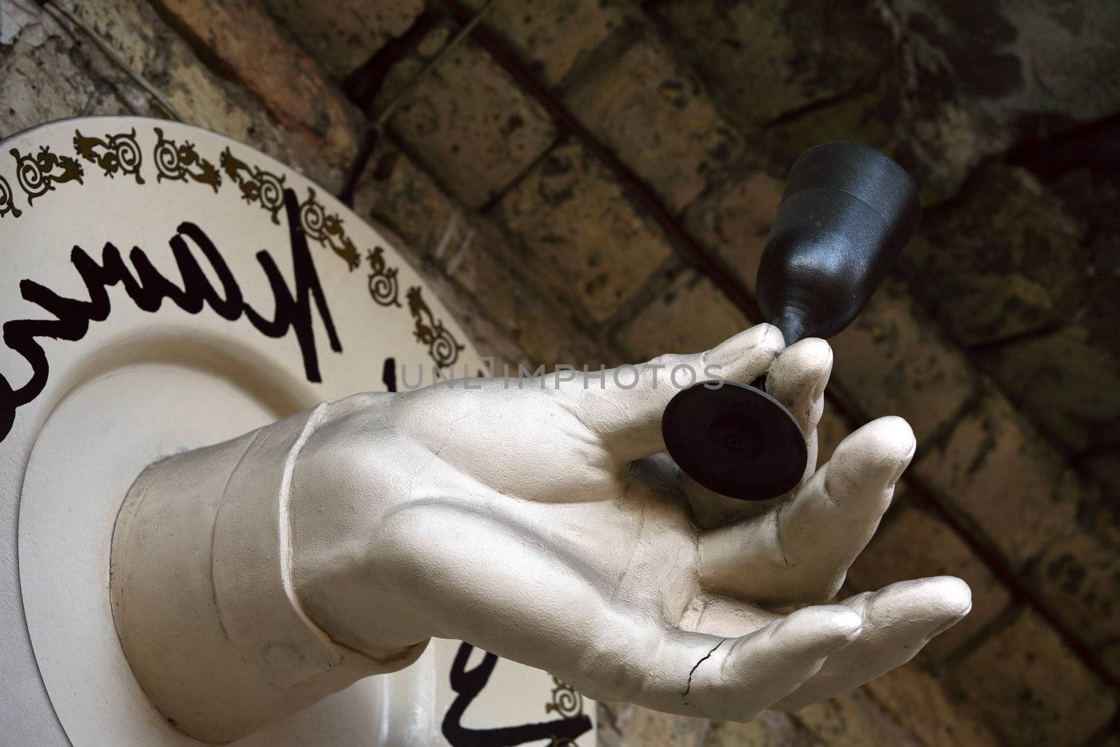 The image of an artificial hand with a glass