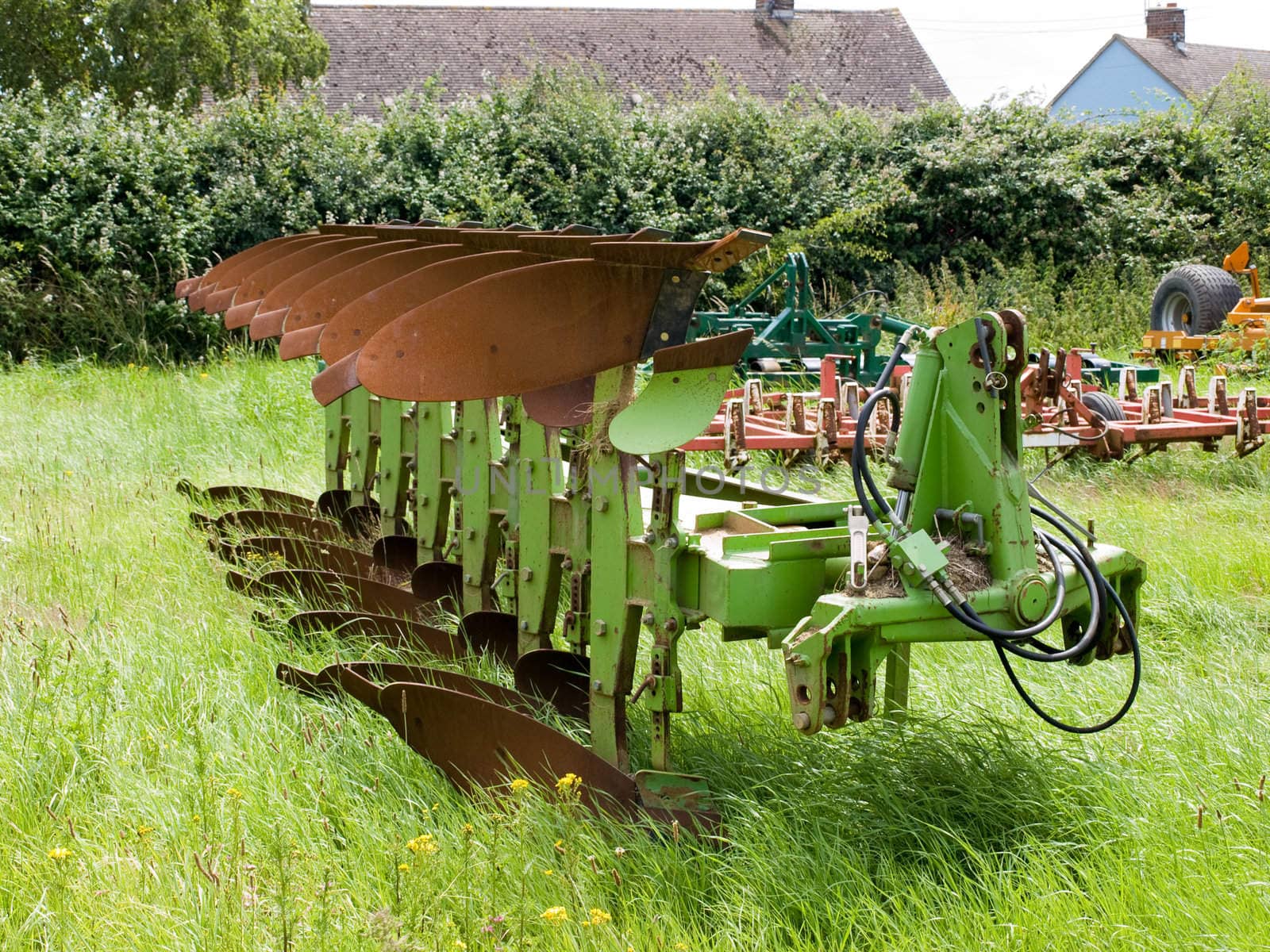 An old plough in a grass field