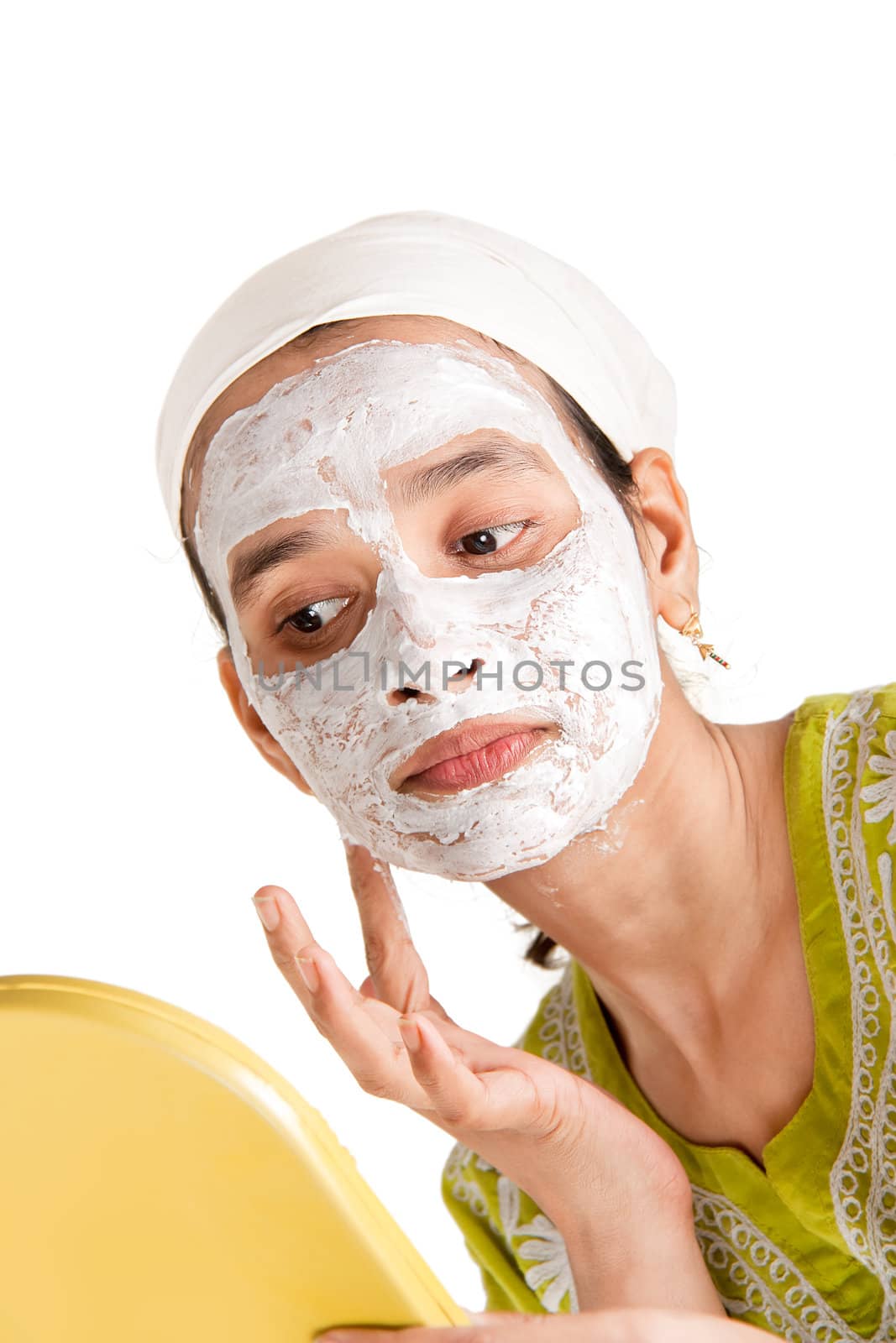 Indian woman with cosmetic mask making it her self