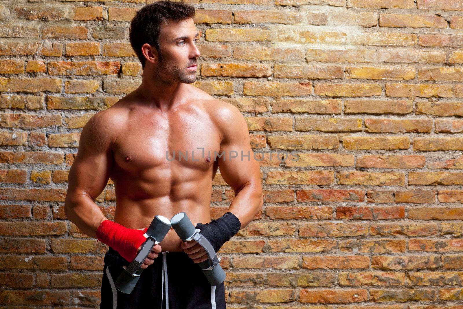 muscle boxer man with fist bandage and training weights