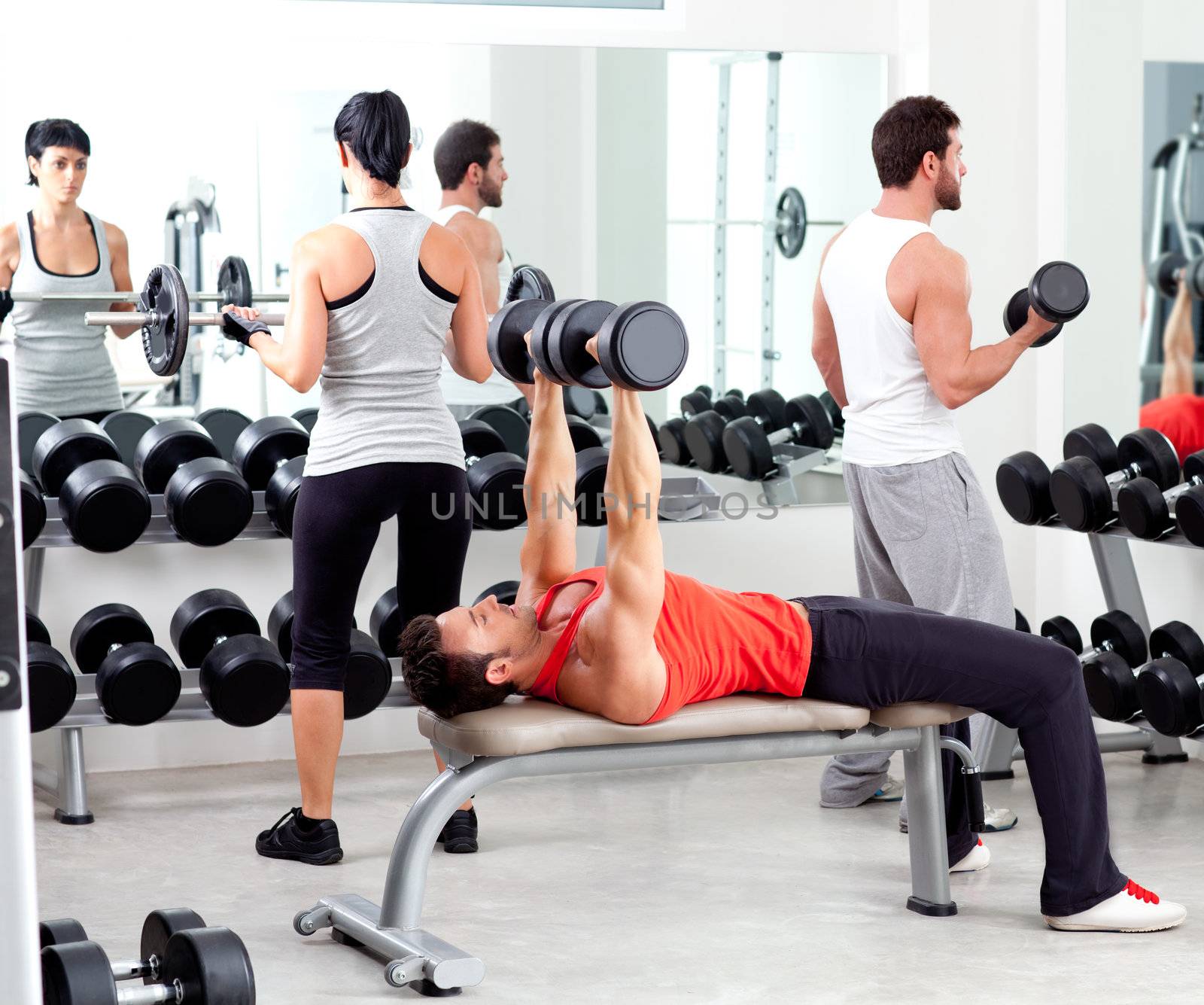 group of people in sport fitness gym weight training equipment indoor