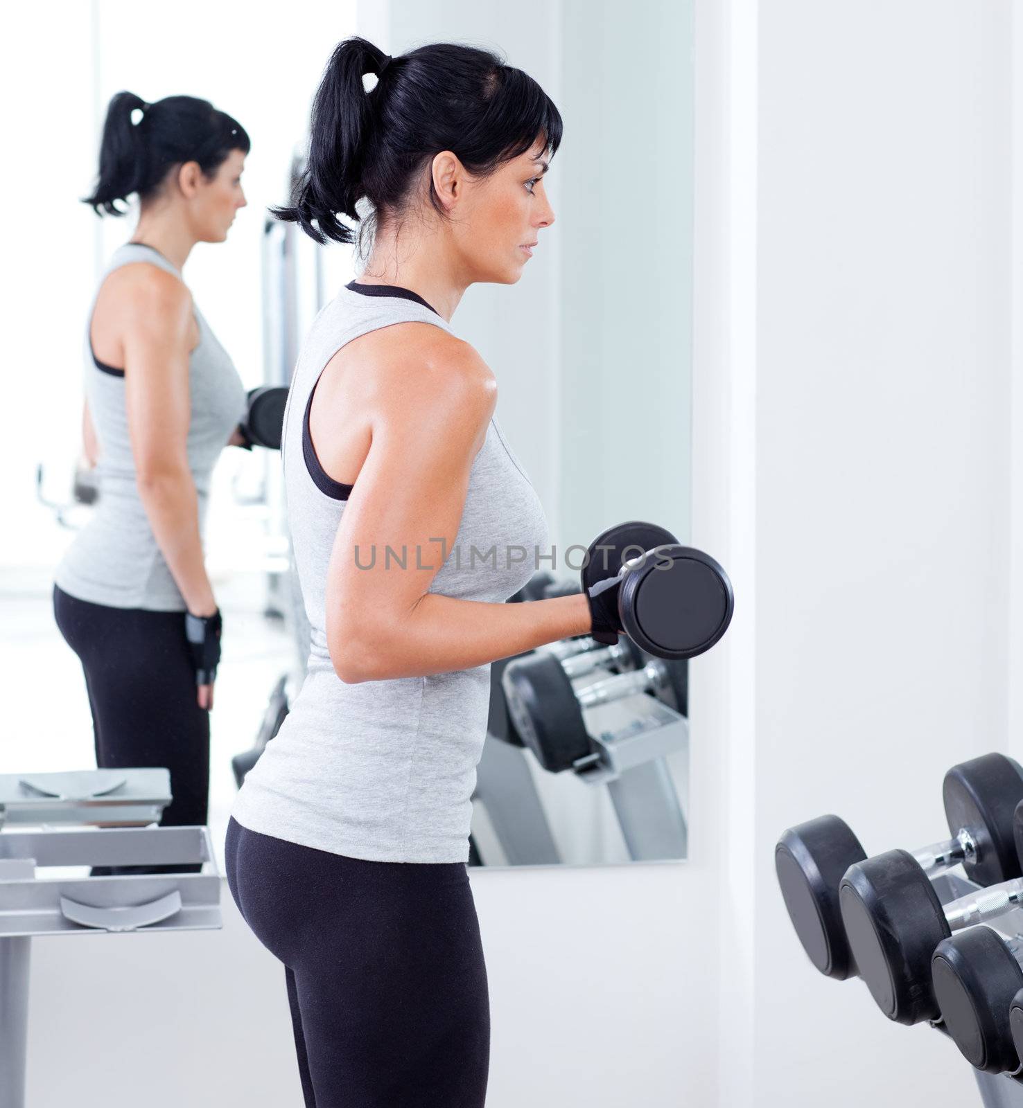 woman with weight training equipment on sport gym club