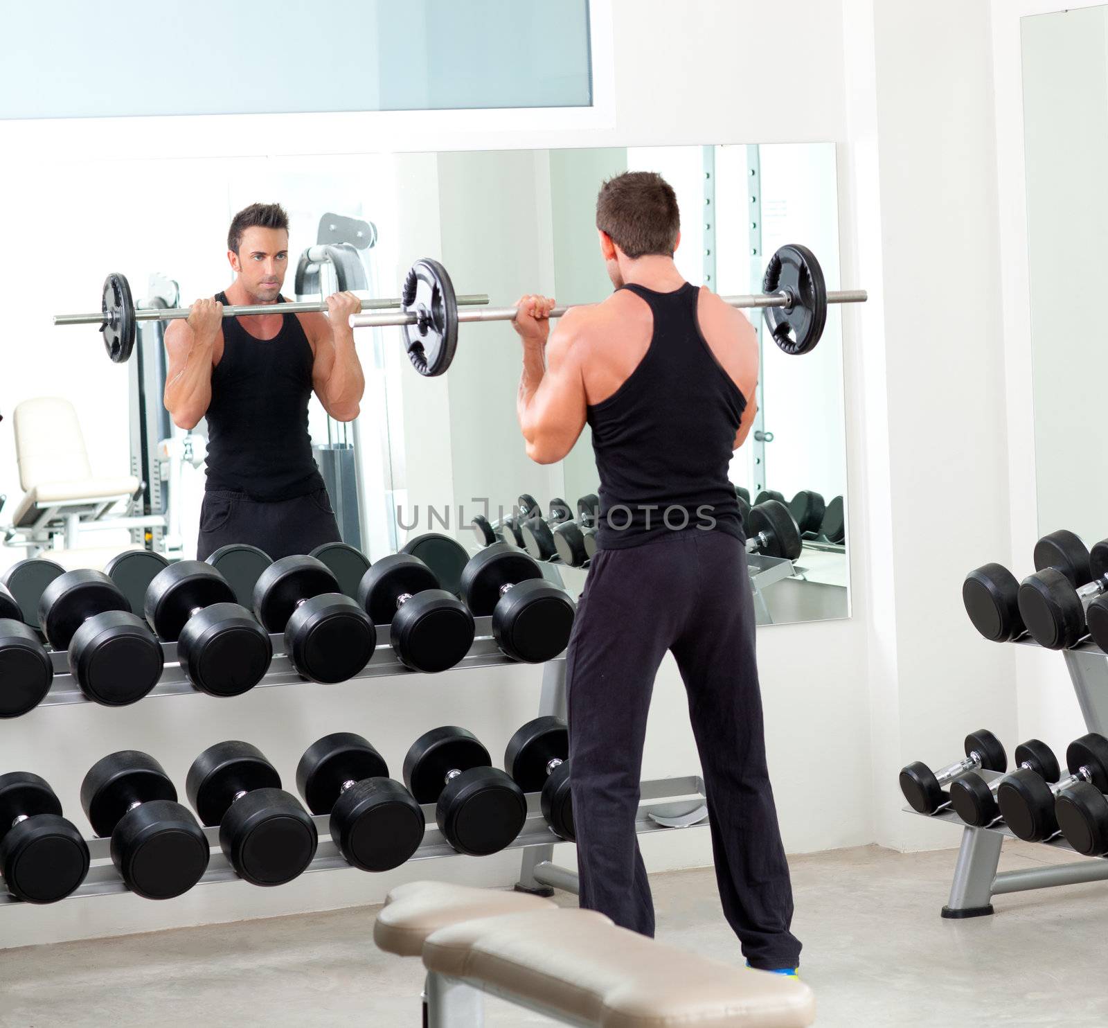 man with dumbbell weight training equipment on sport gym