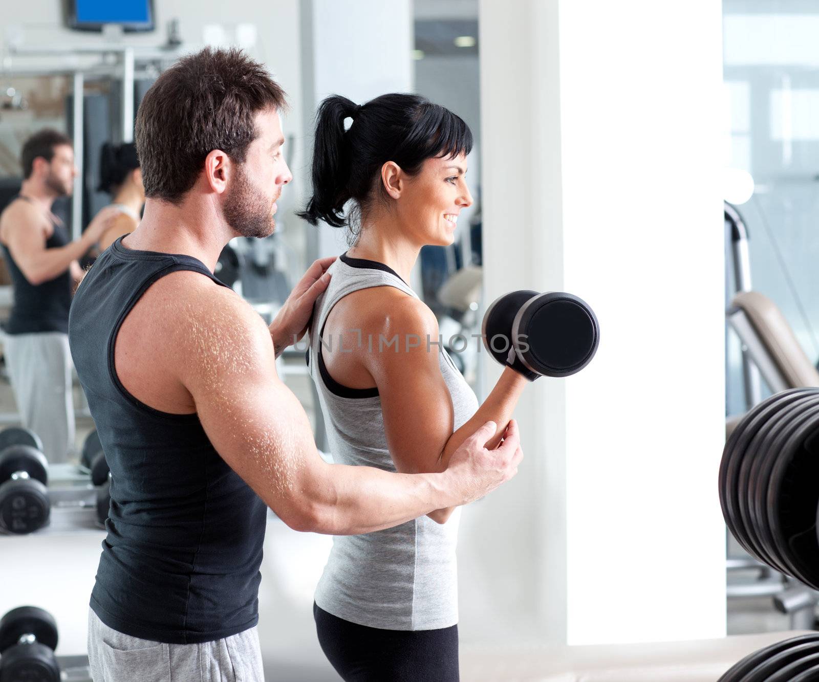 gym woman personal trainer with weight training by lunamarina
