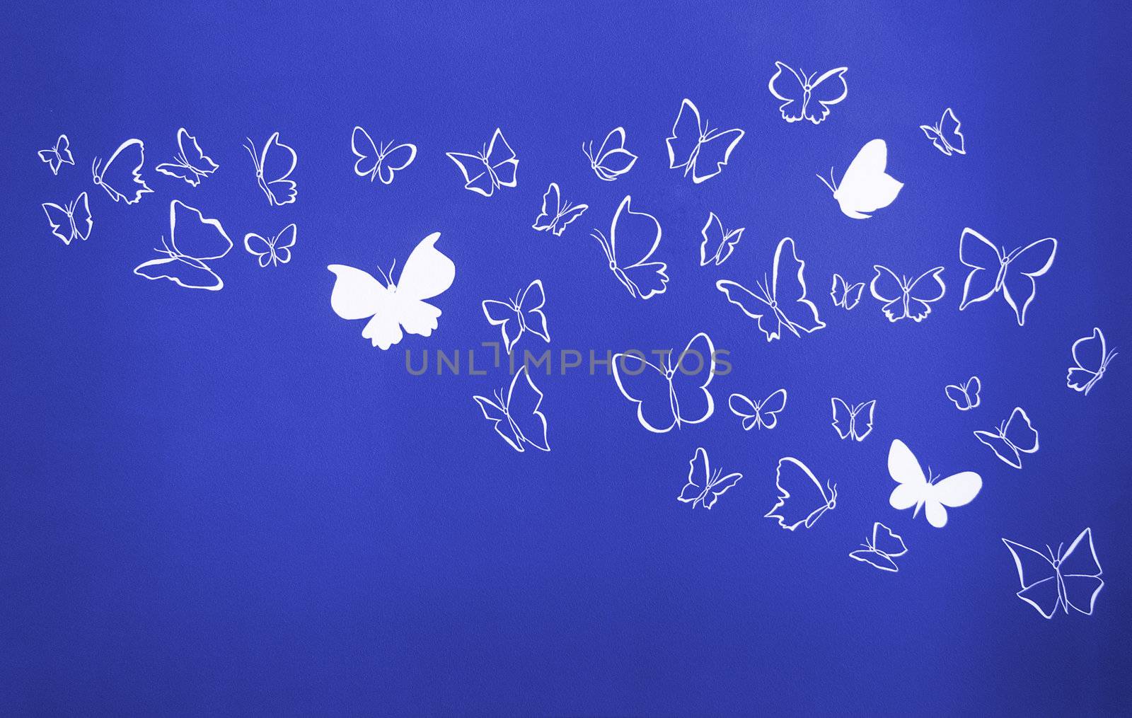 Group of white silhouettes butterflies flying over a blue background