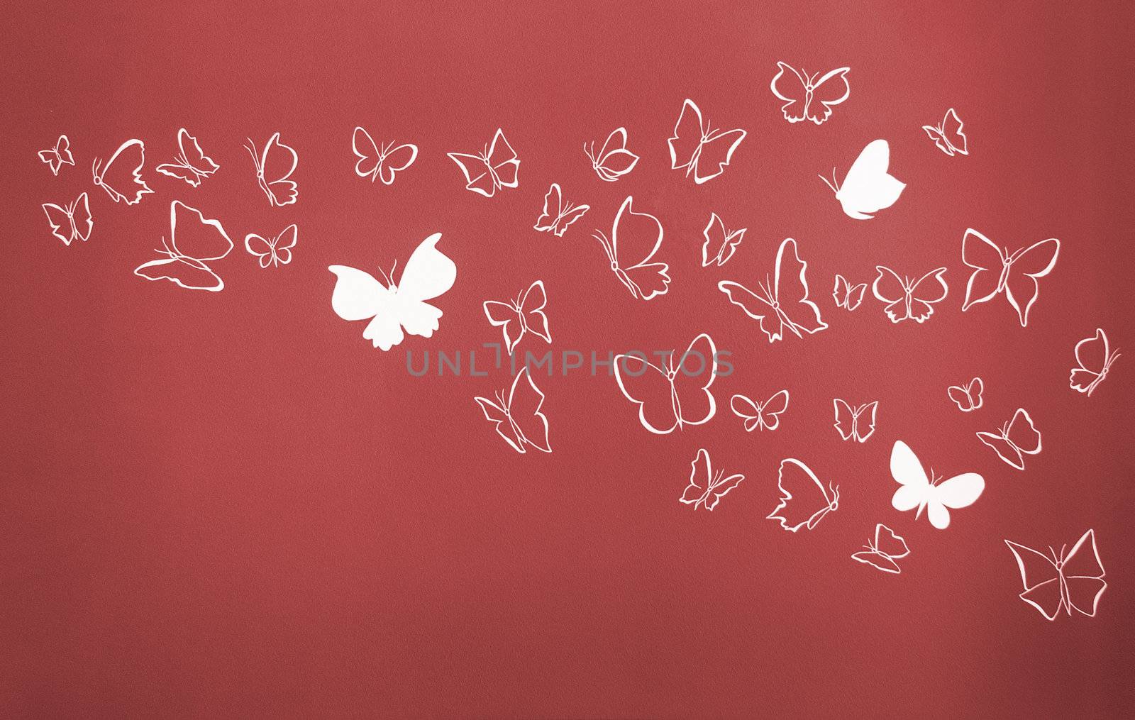 Group of white silhouettes butterflies flying over a red background