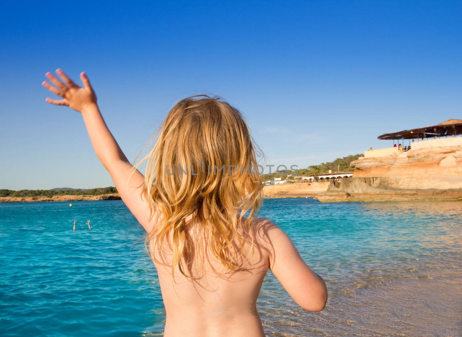 Ibiza Cala Conta beach little girl greeting hand sign saying bye