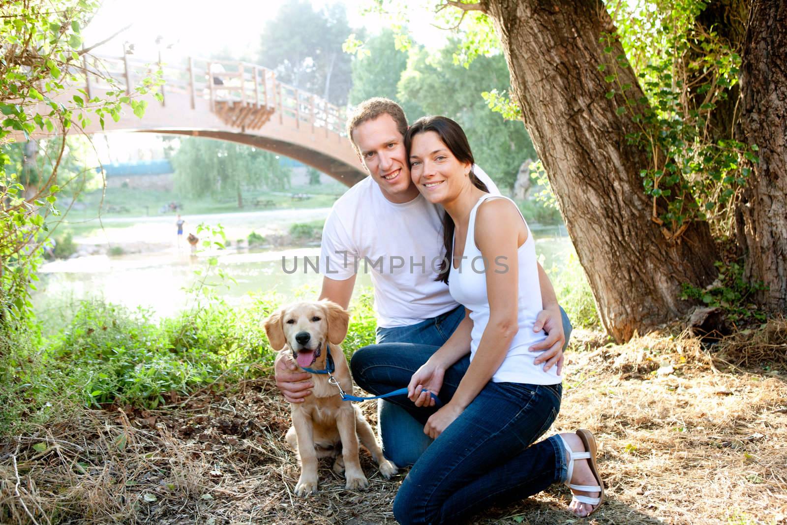 Couple in love with dog in outdoor river by lunamarina