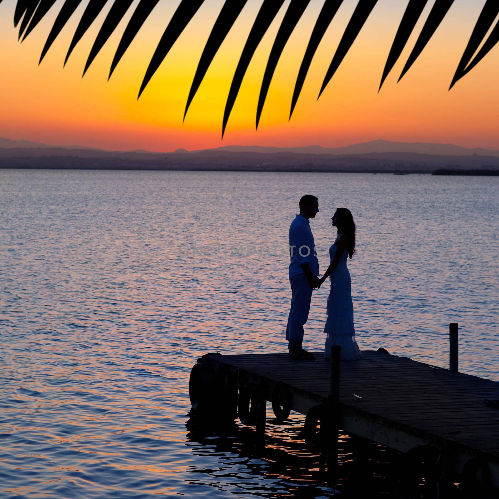 couple in love back light silhouette at lake by lunamarina