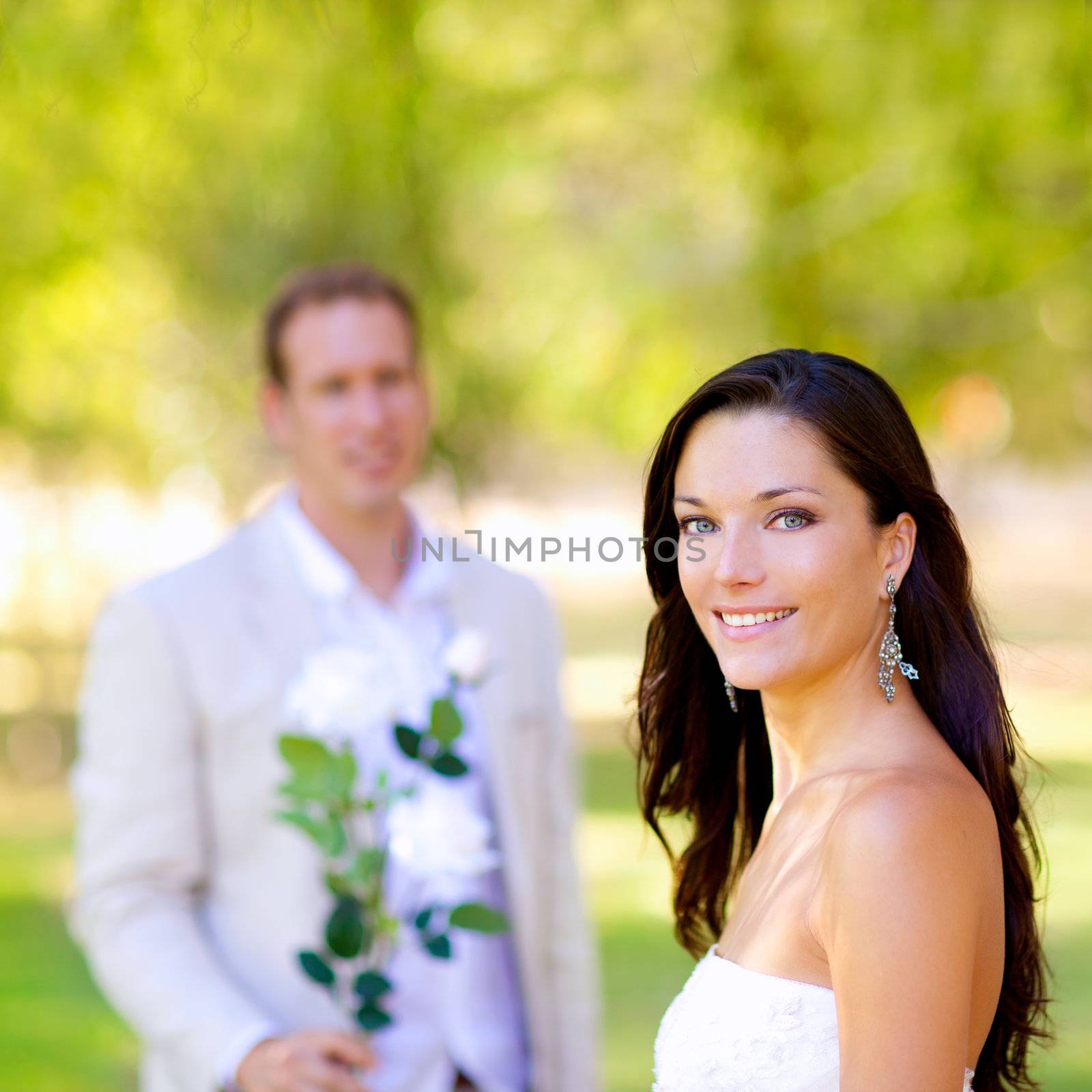 couple just married with man holding flowers by lunamarina
