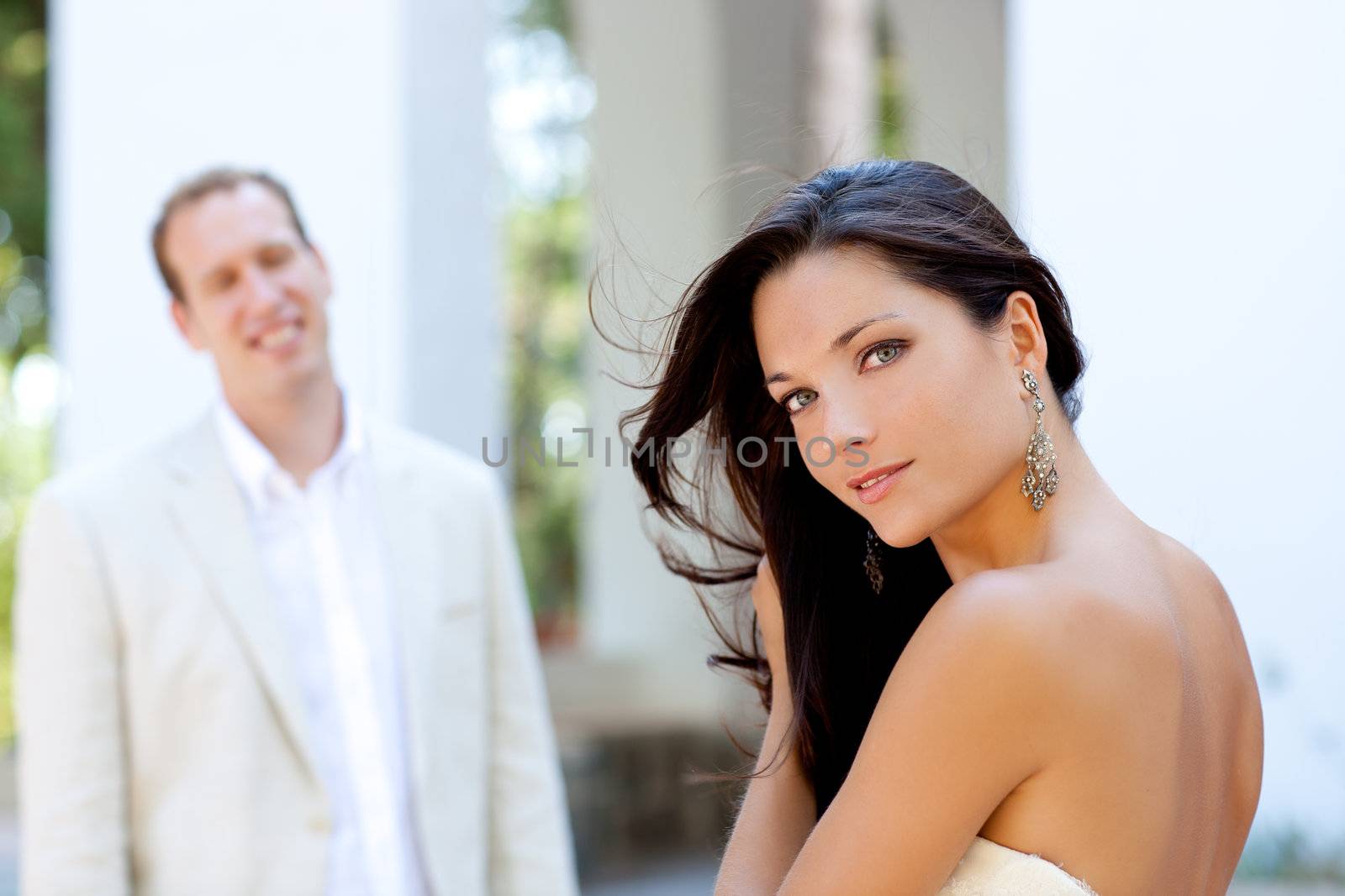 Happy beautiful woman portrait with man in blur background