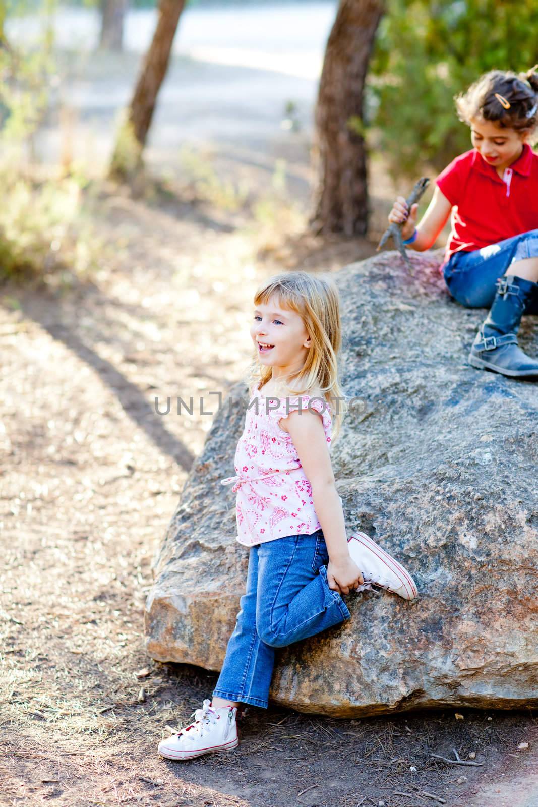 friends kid girls playing in forest rock outdoor