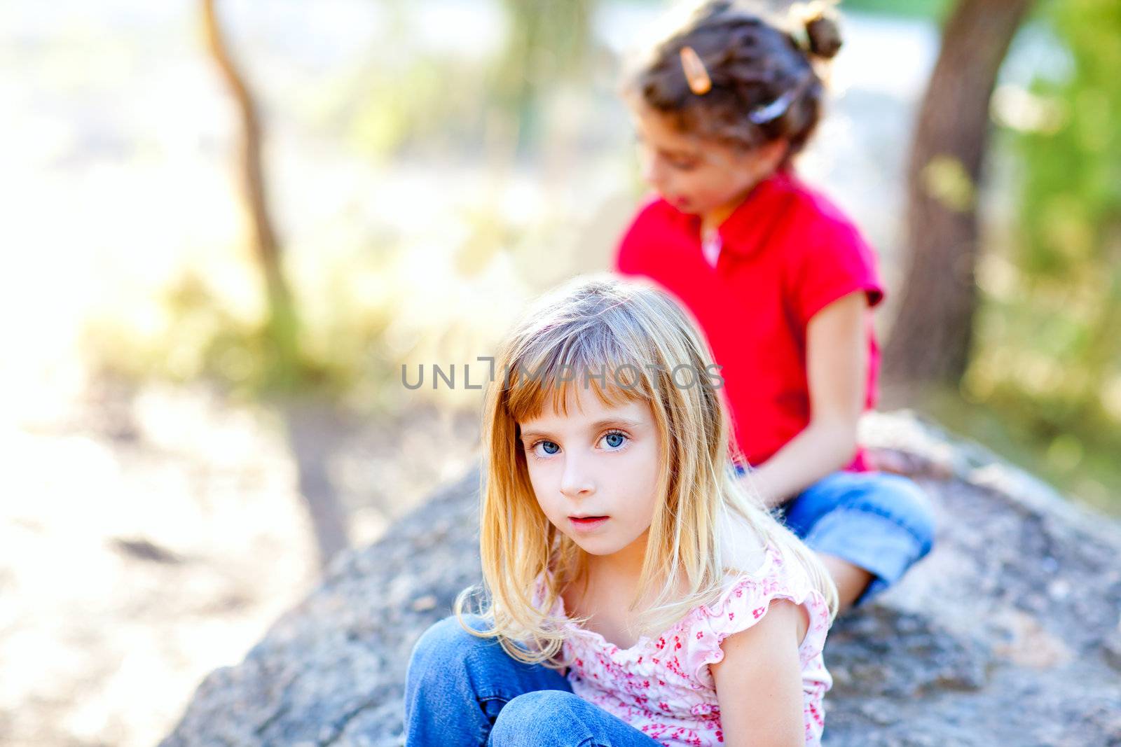 friends kid girls playing in forest rock outdoor