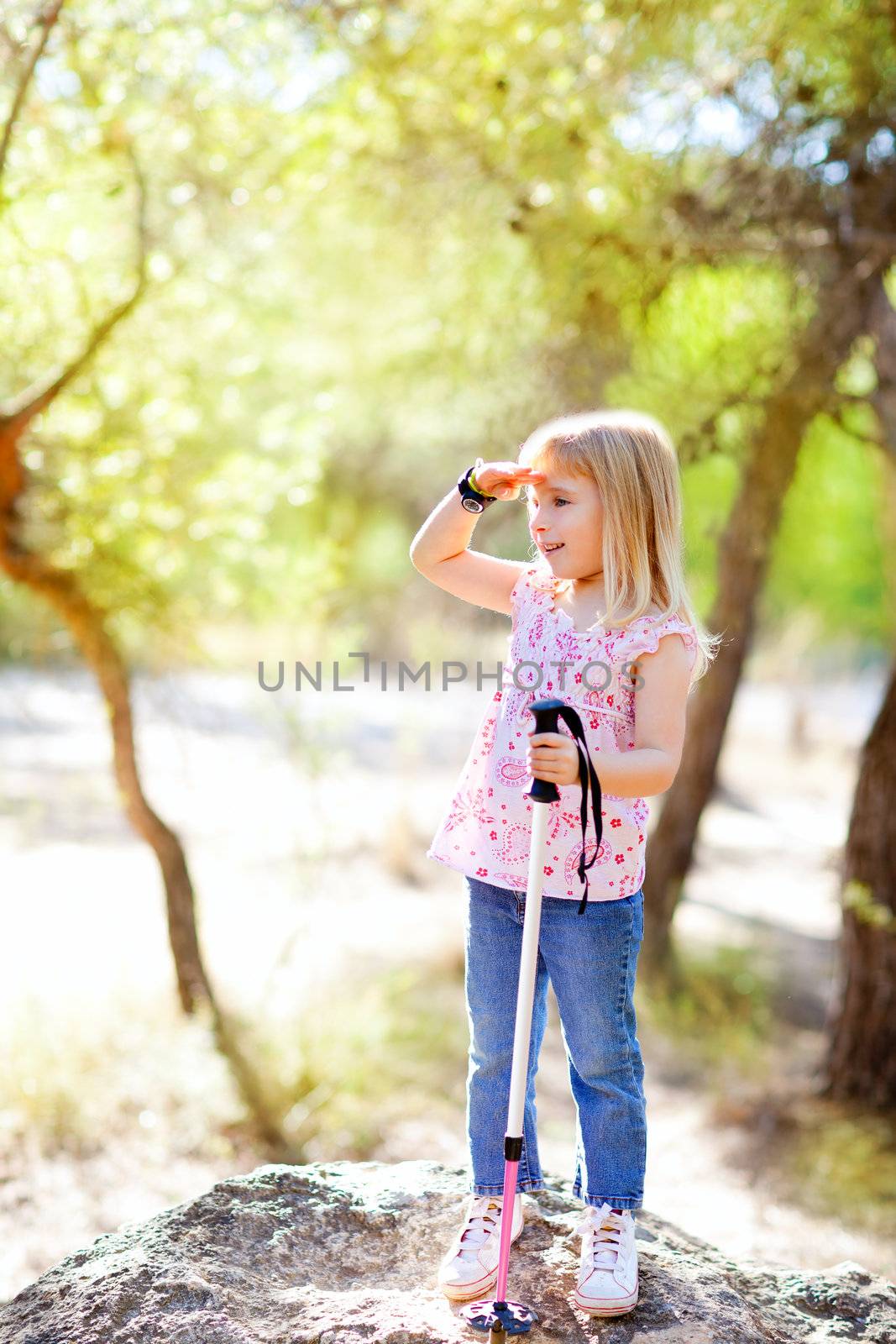 hiking kid girl searching hand in head in forest outdoor