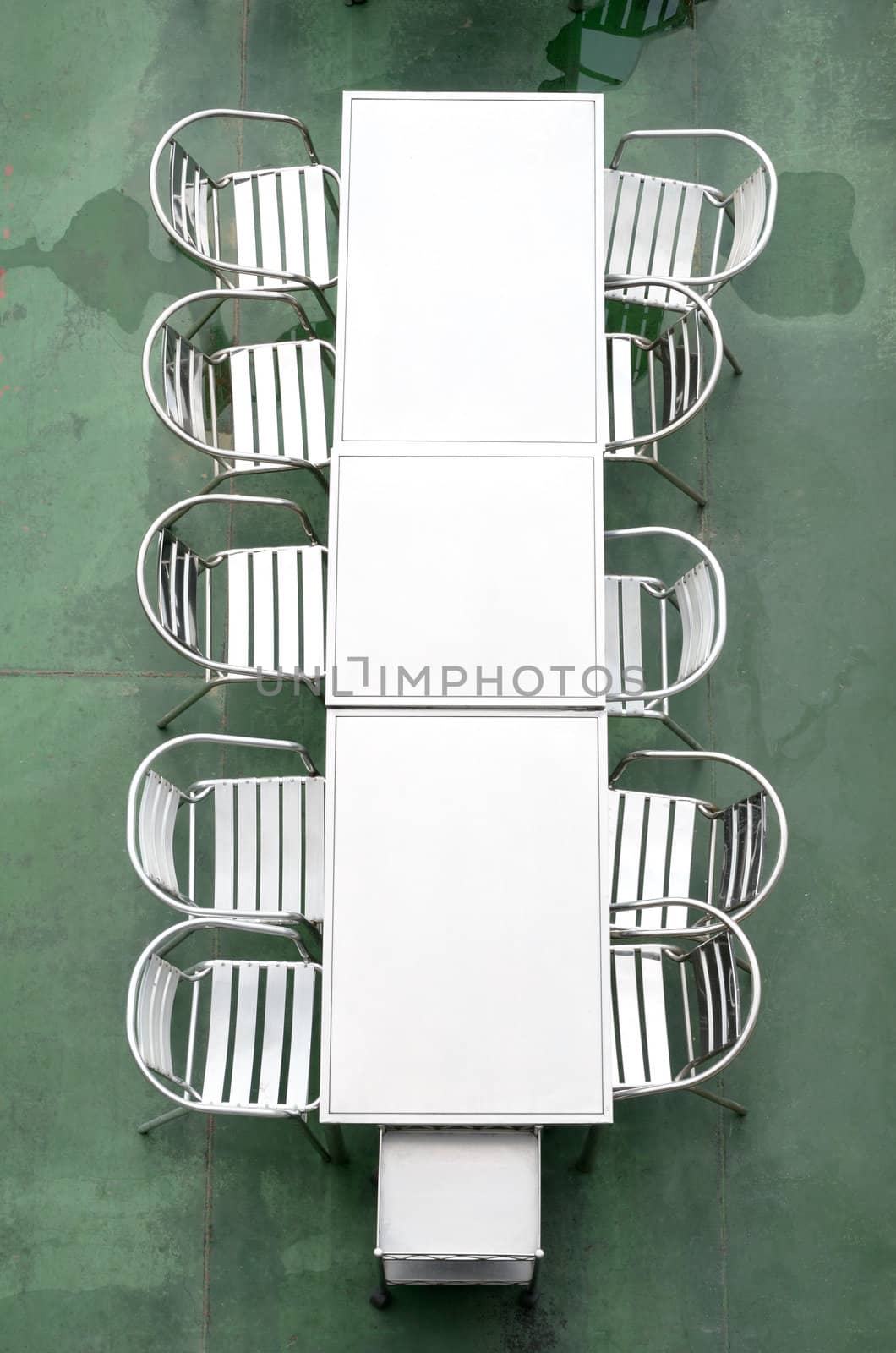 Top view of Metal table and chair with wet floor 