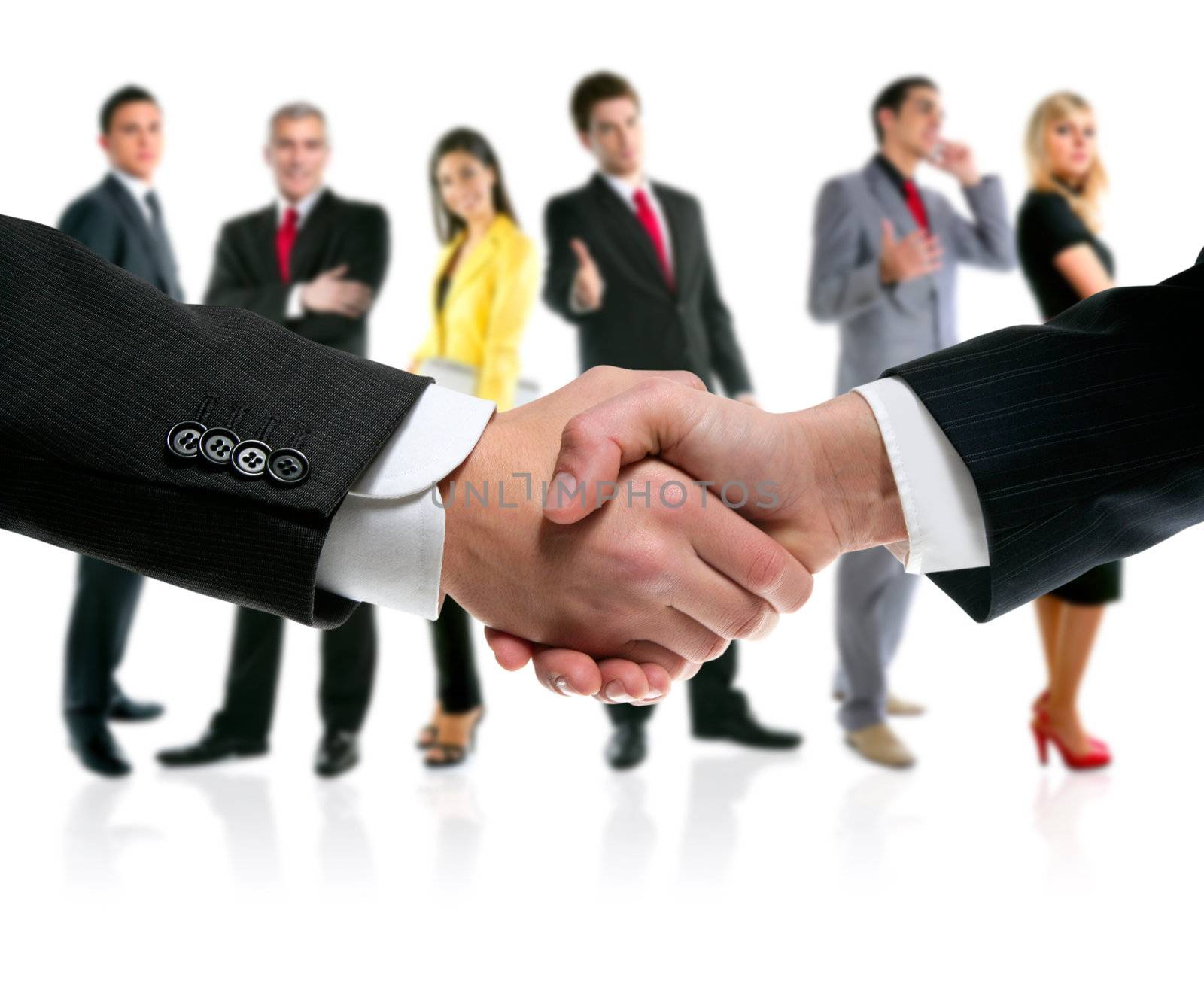 business people handshake with company team in background