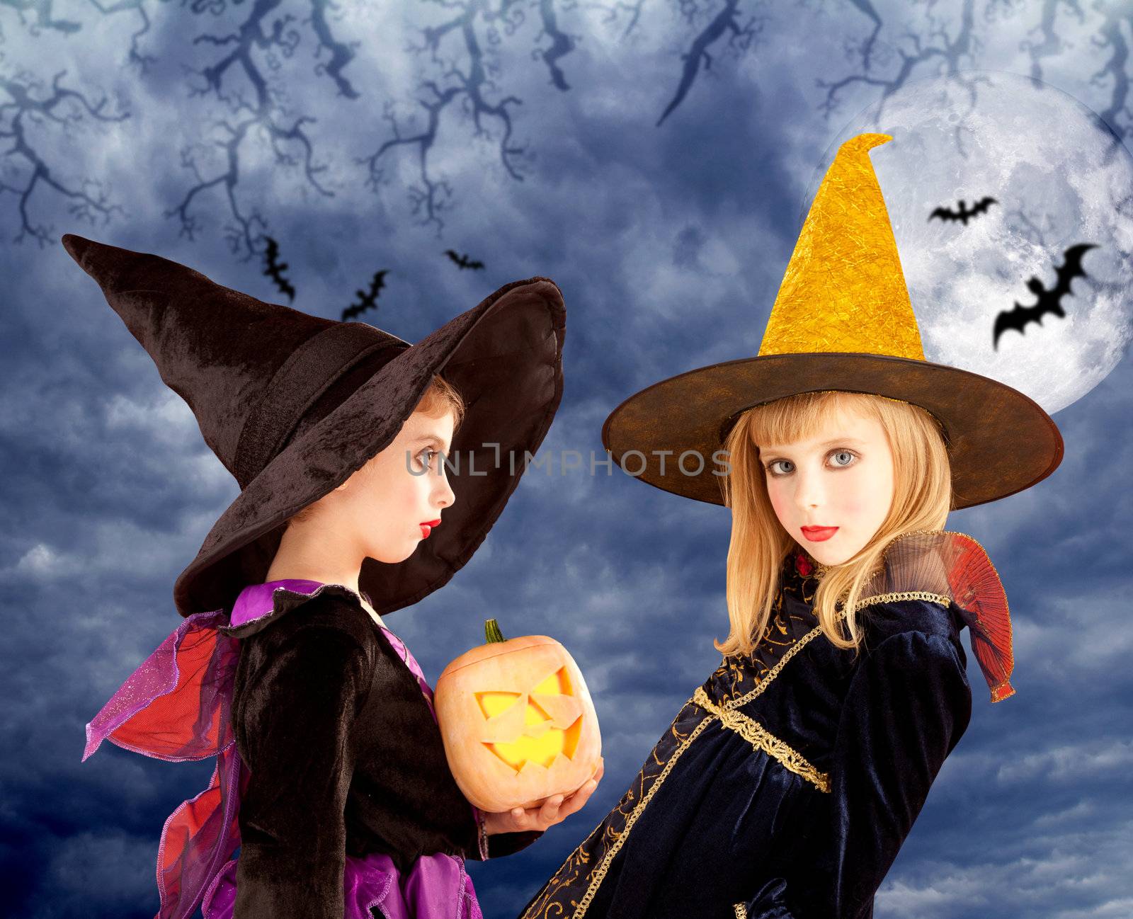 Halloween kid girls and pumpkin on cloudy moon sky