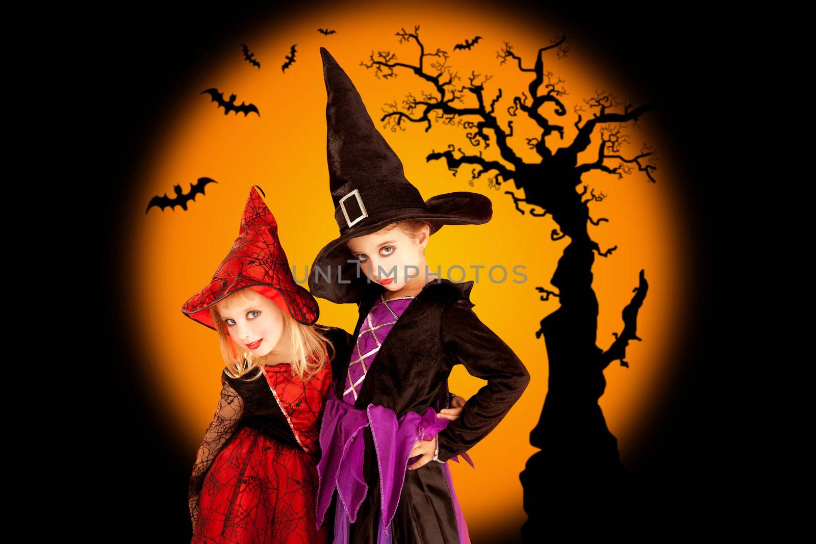 Halloween two children girls with tree and bats on orange background