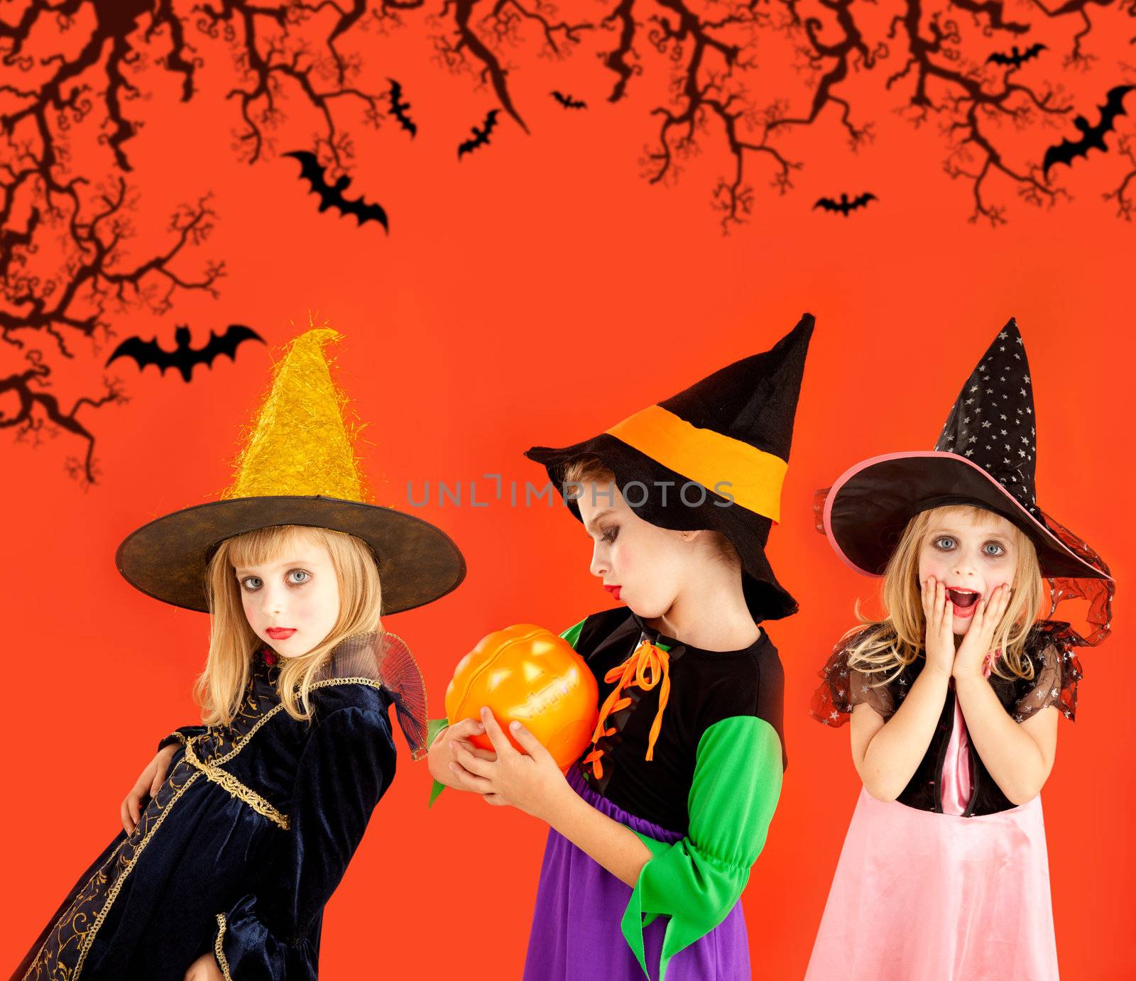 Halloween group of children girls costumes on orange background