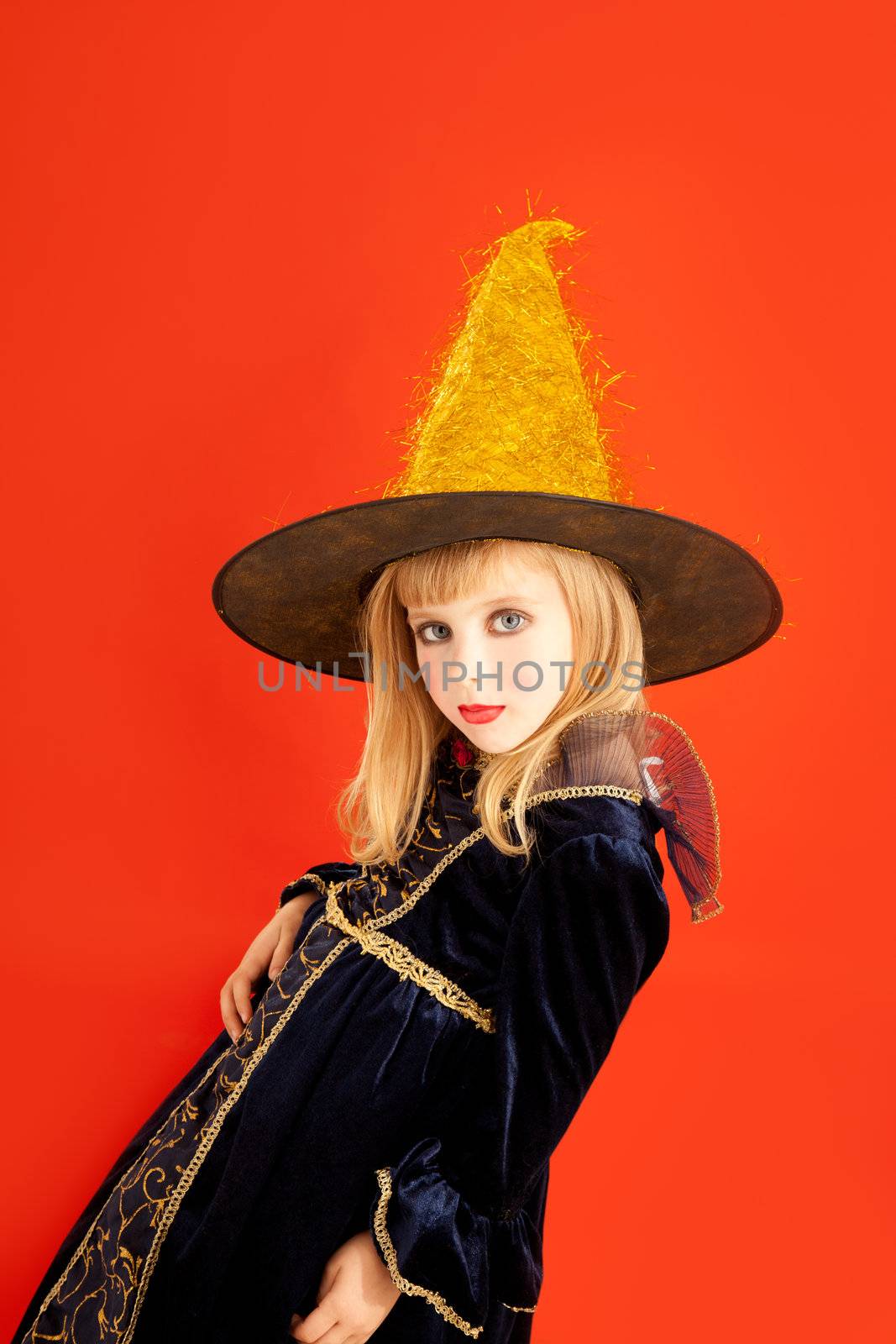 Halloween kid girl costume on orange background