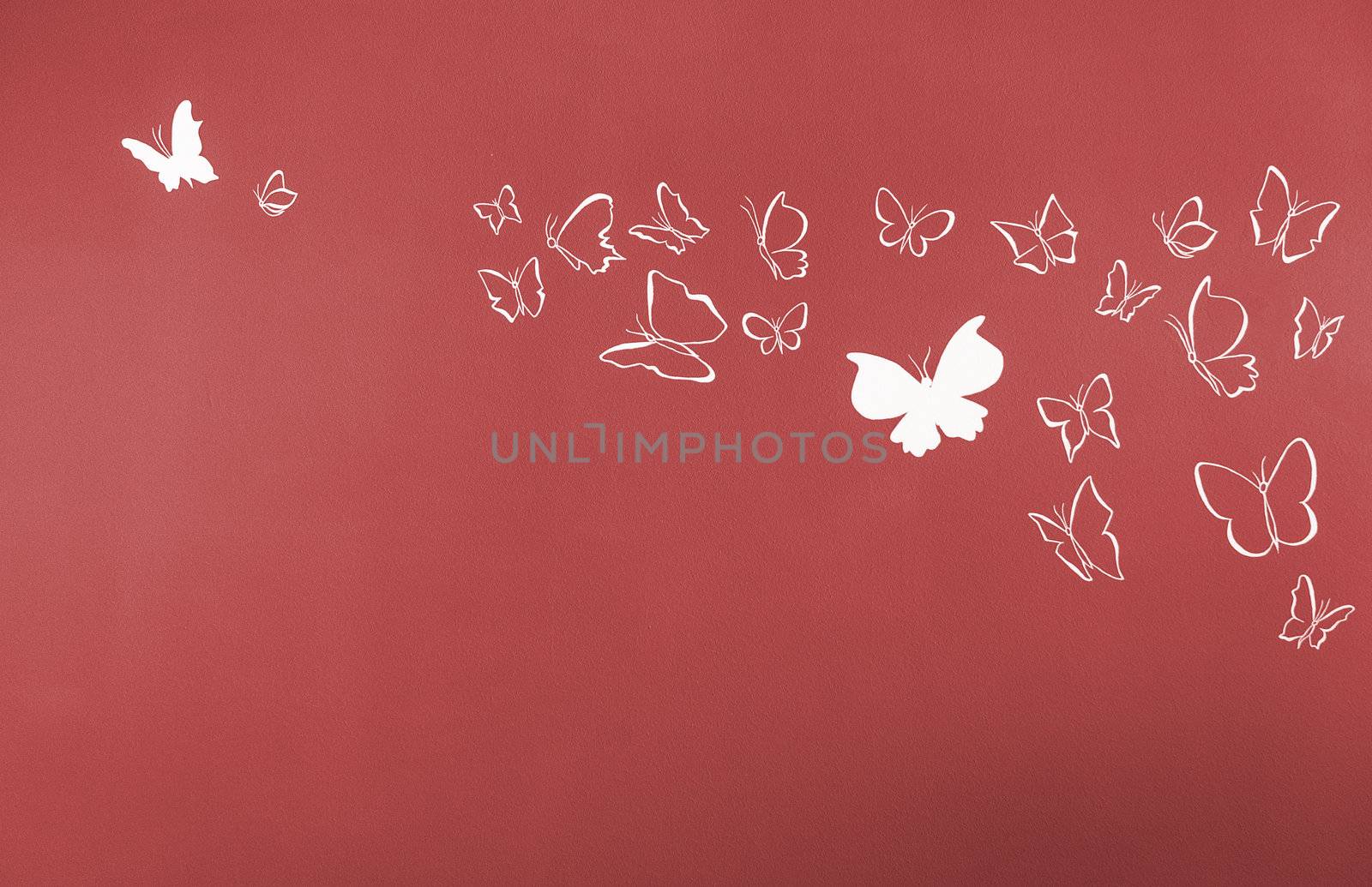 Group of white silhouettes butterflies flying over a red background