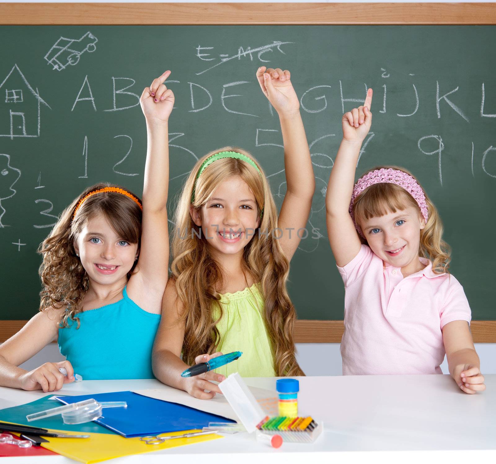 smart group of student kids at school classroom raising hand