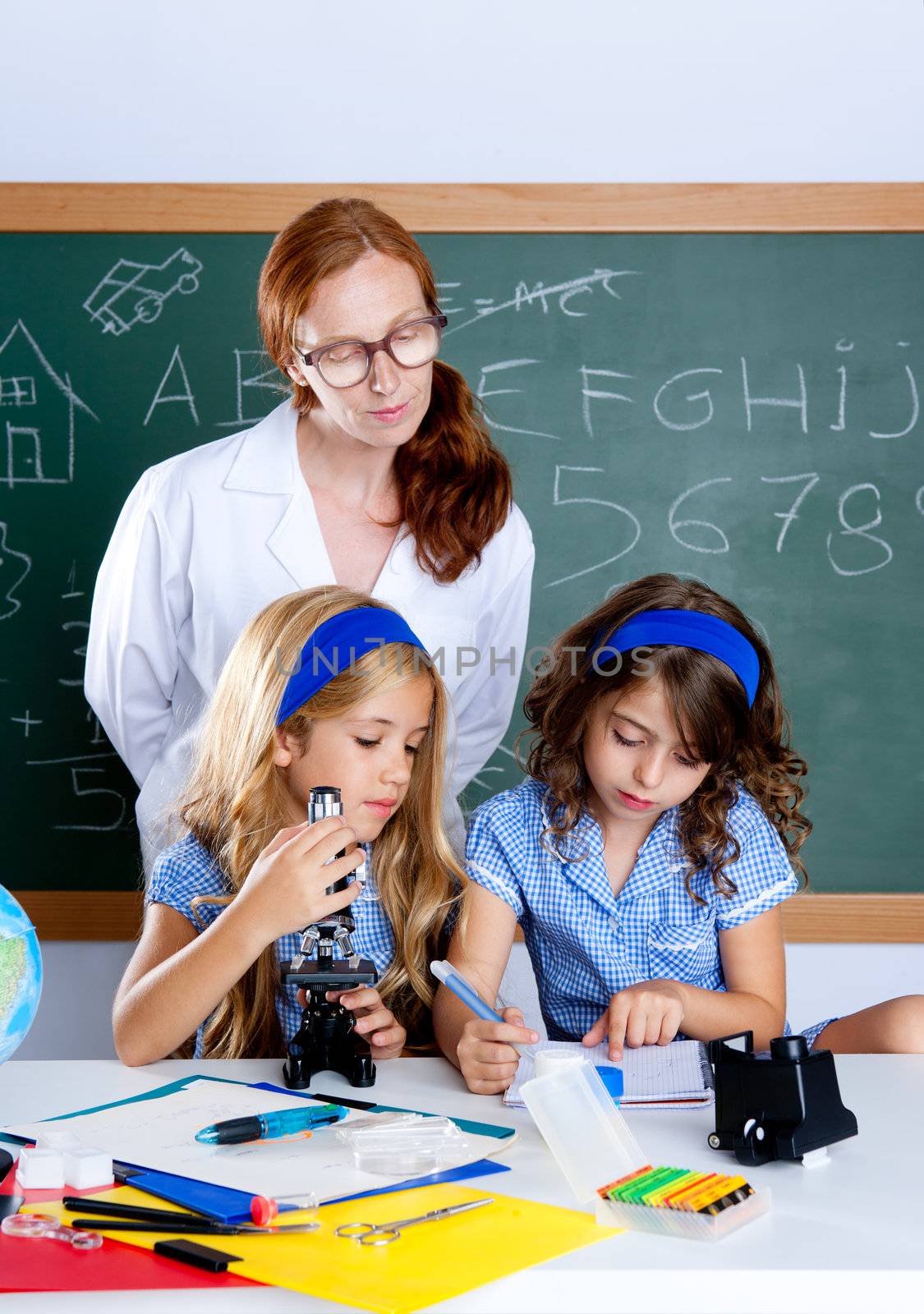 kids students with nerd teacher woman at science classroom