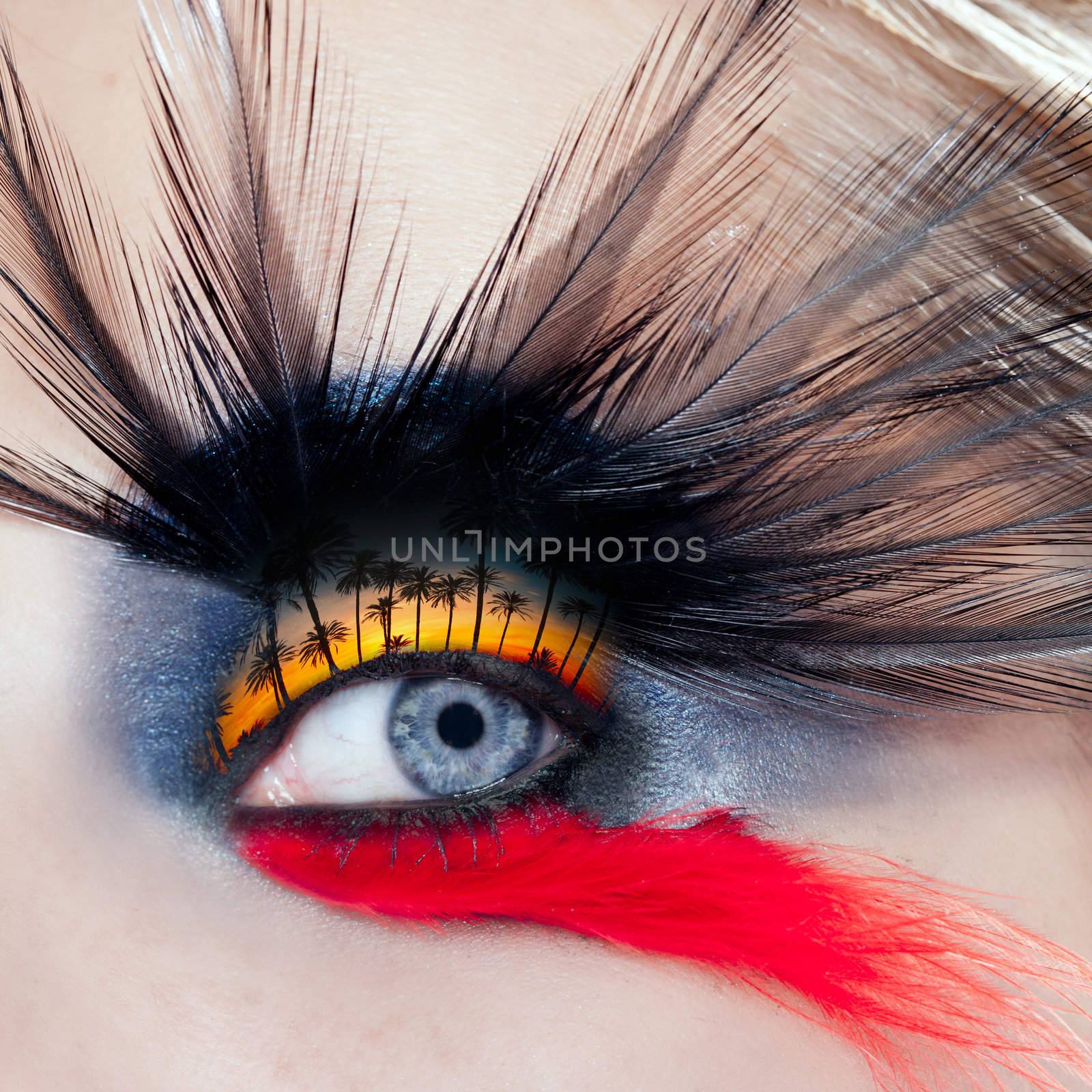 blue woman eye makeup bird inspired with black and red feathers and palm tree sunset in eyelid