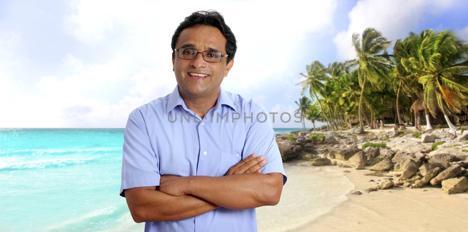 Indian man tourist portrait in tropical caribbean beach with palm trees