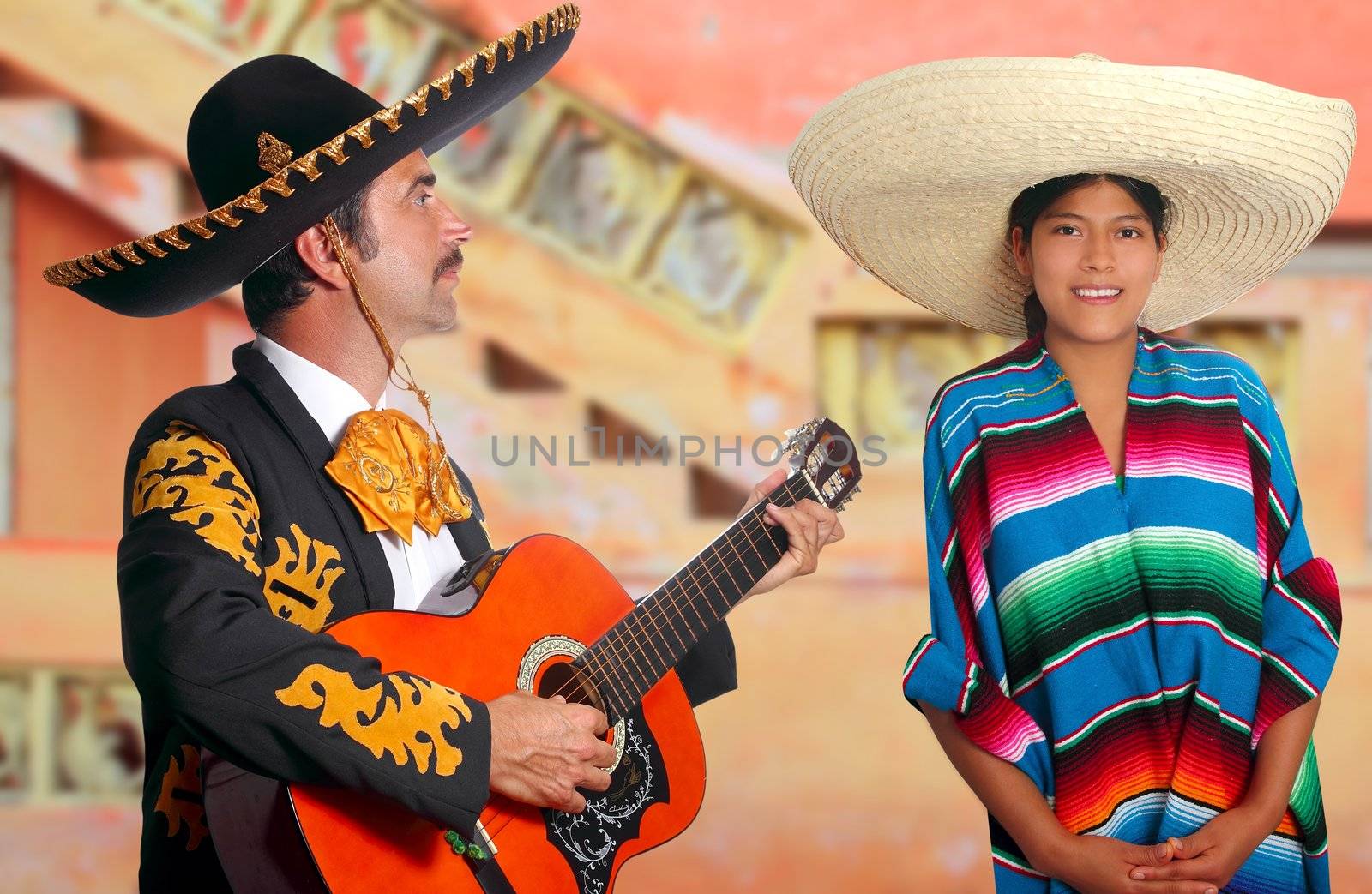 Mexican mariachi charro man singing a song to a poncho Mexico girl