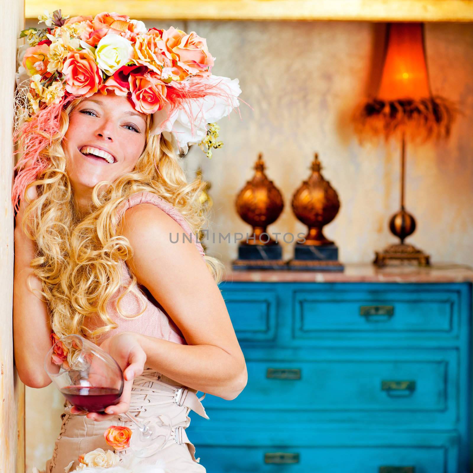 baroque fashion blond womand drinking red wine in grunge house
