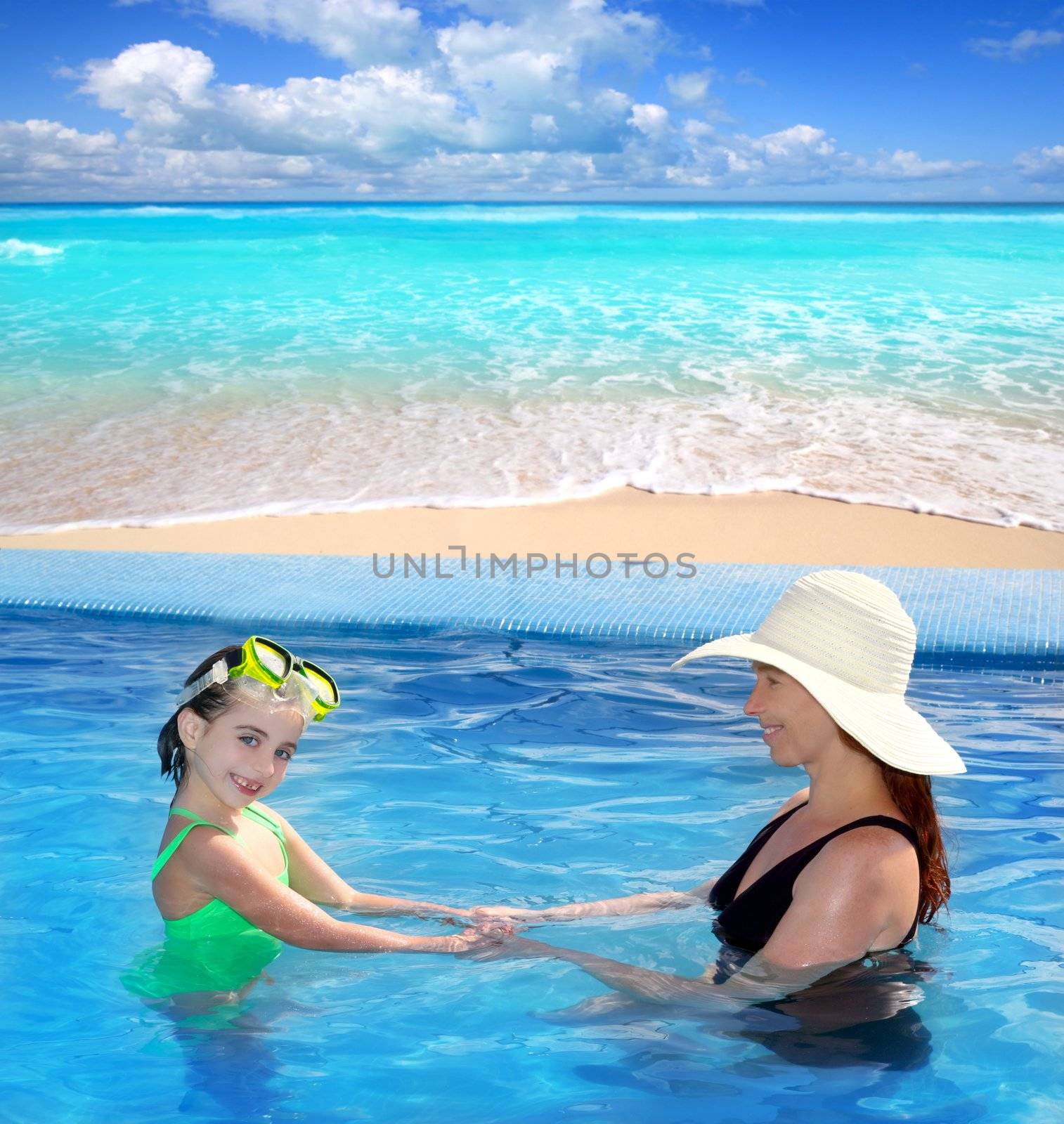 daughter and mother in swimming pool with direct view to a tropical Caribbean beach
