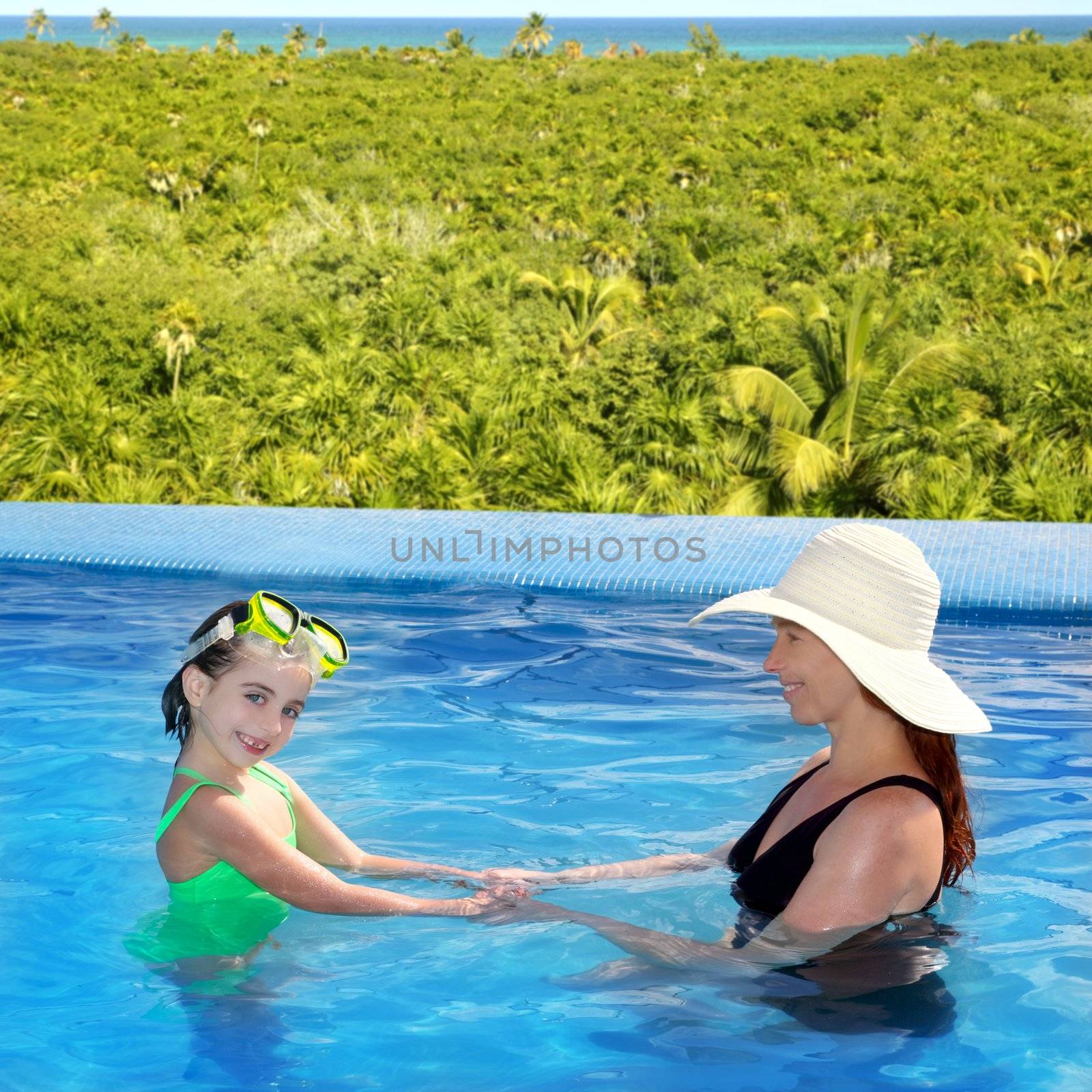 daughter and mother in swimming pool tropical by lunamarina
