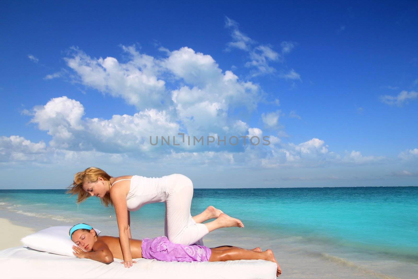 Caribbean beach therapy shiatsu massage on knees women in paradise