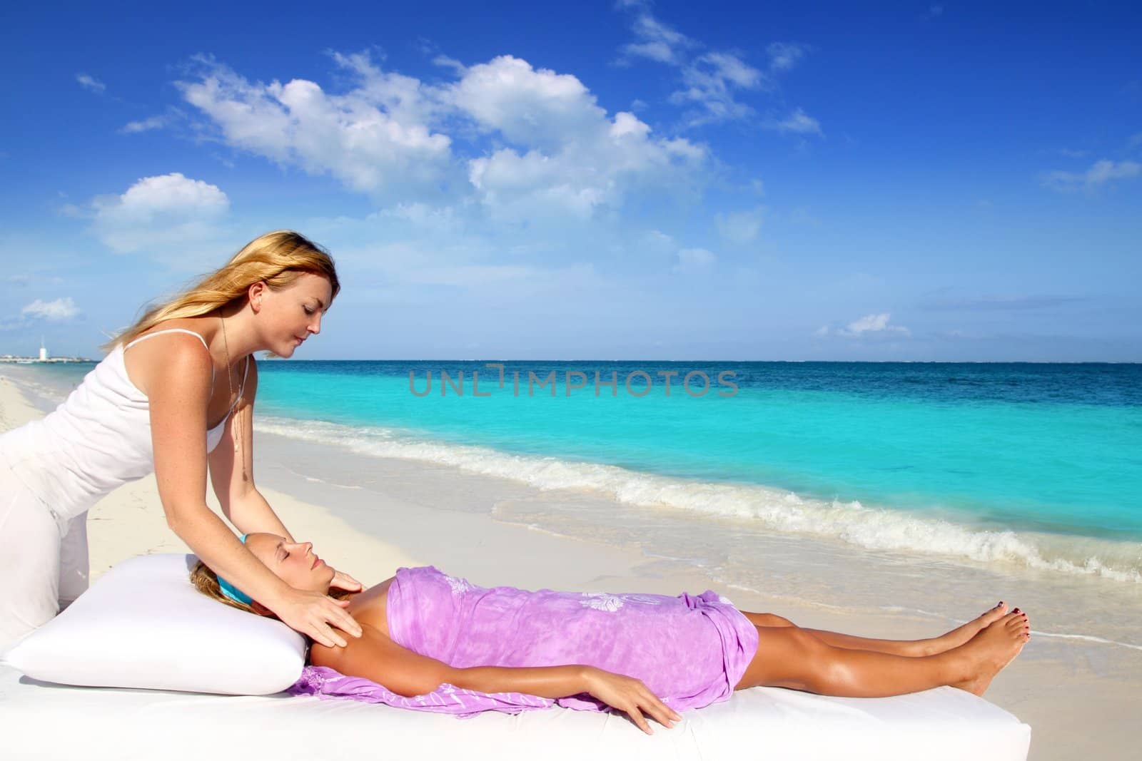 Mayan reiki therapy massage in Caribbean beach with two women