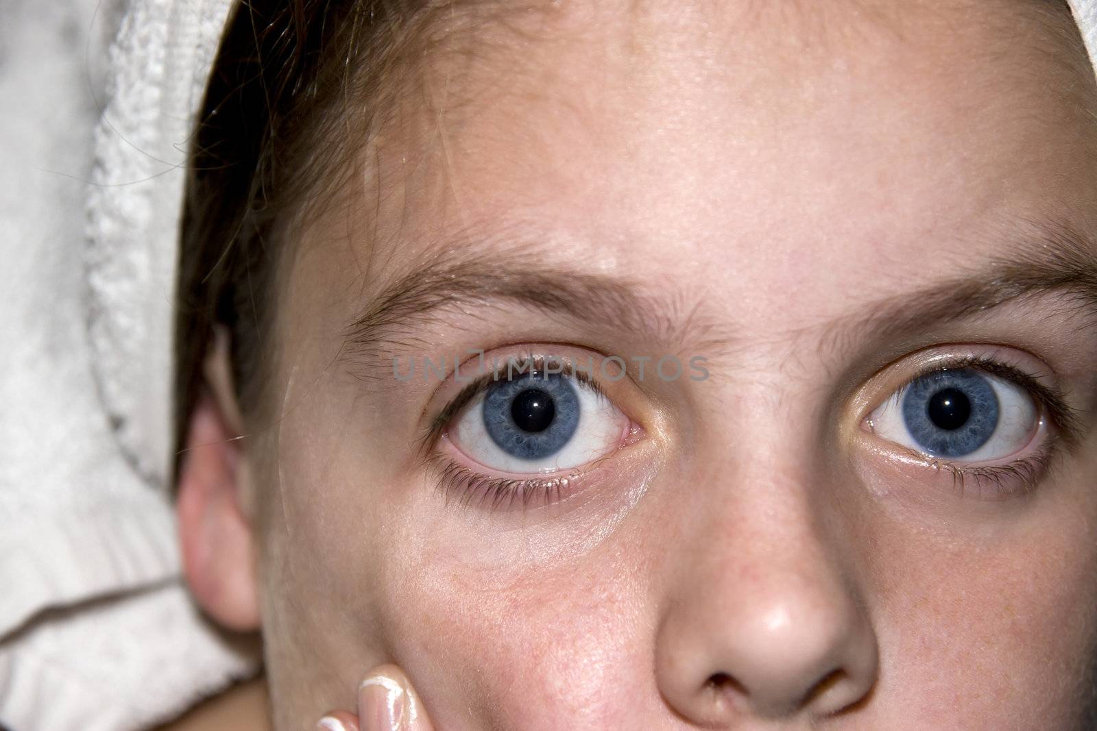 Portrait of a young teenage blue eyed girl looking straight into the camera