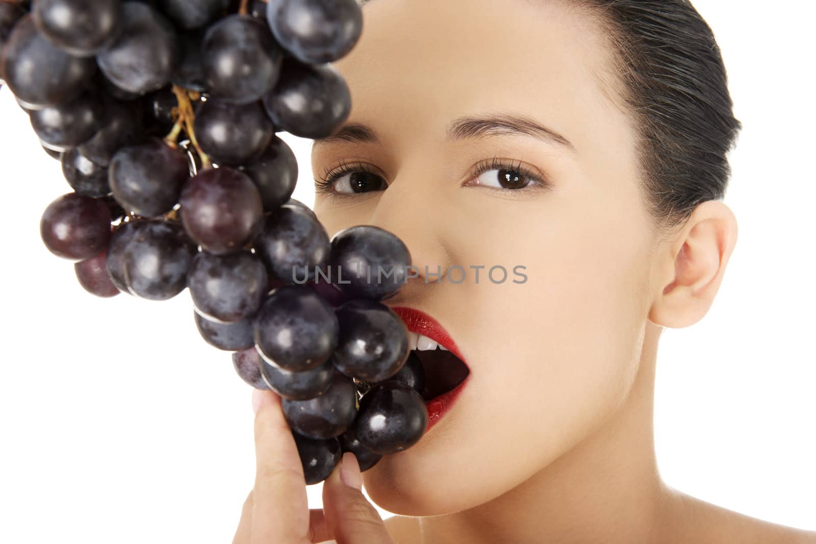 Beautiful sensual brunette eating grapes by BDS