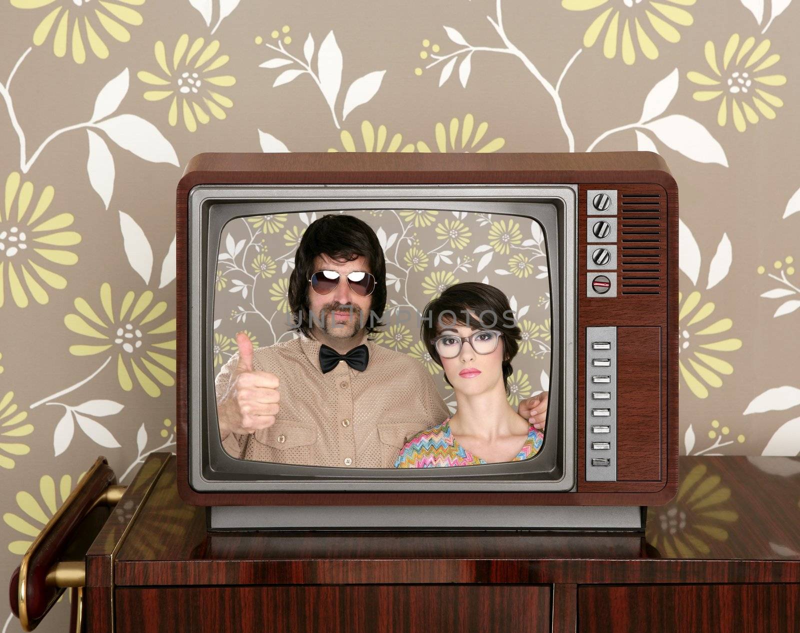 old wooden tv with nerd silly couple retro in screen on wallpaper background