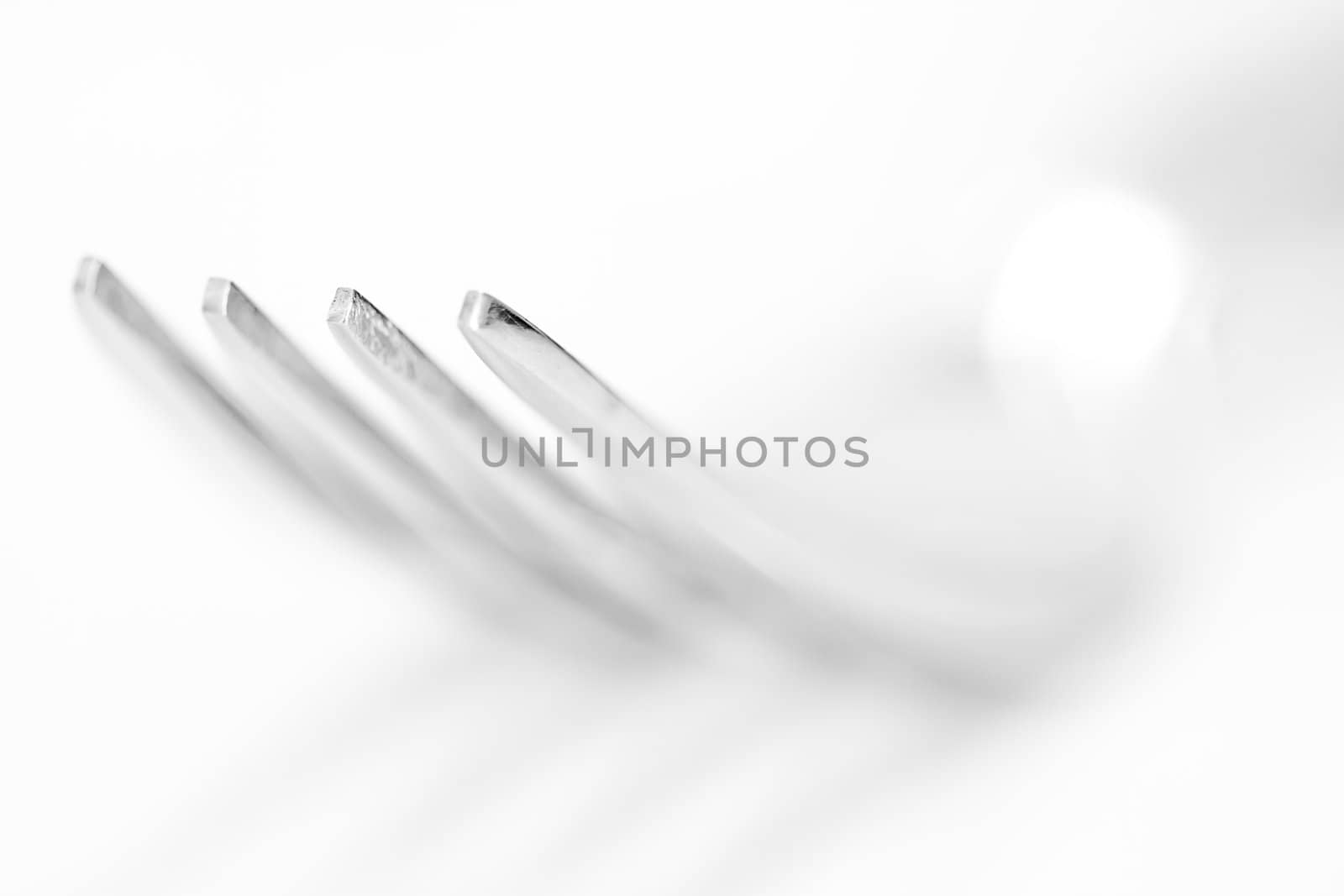 The fork on the white background, shallow depth of field