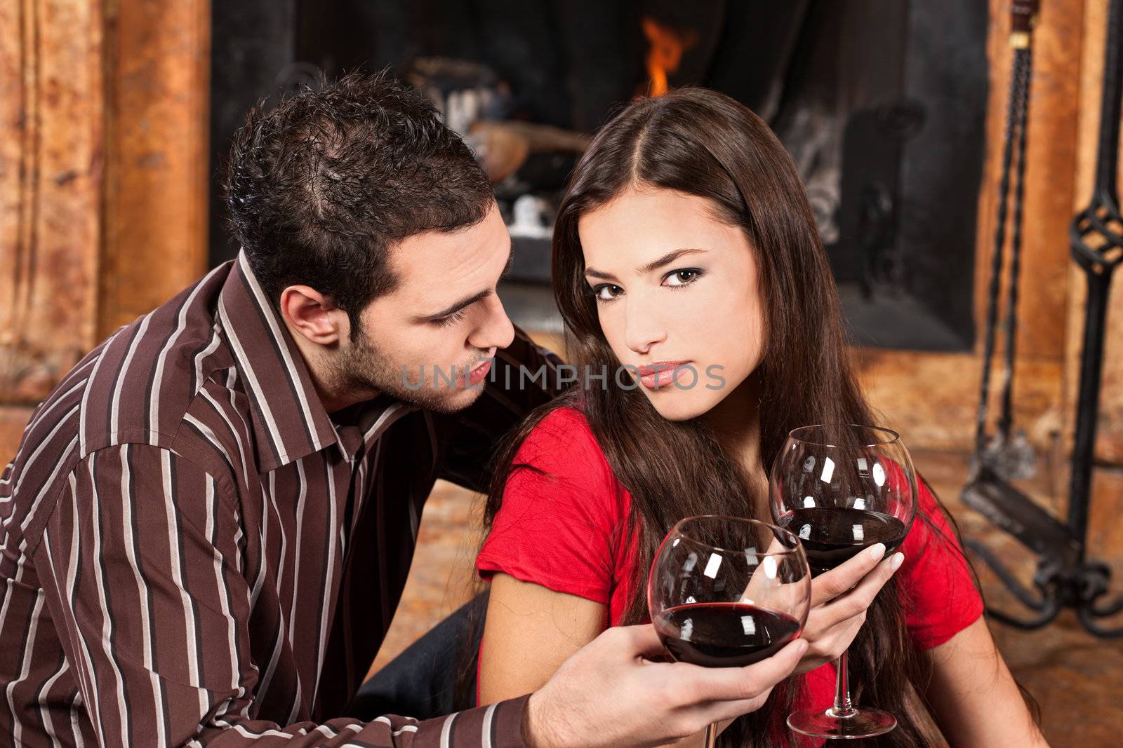 couple in love near fireplace by imarin