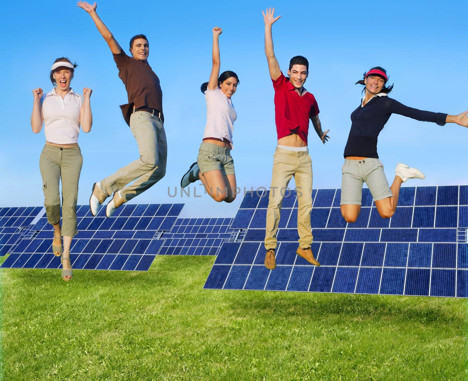 Jumping young people happy group green energy solar plates