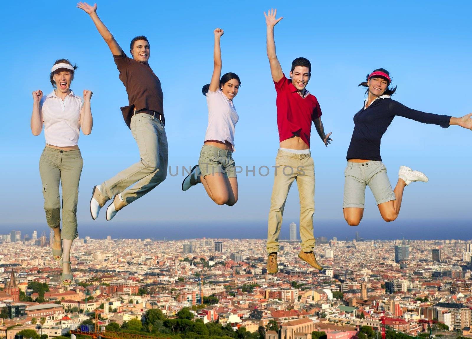 Jumping young people happy group over city buildings cityscape